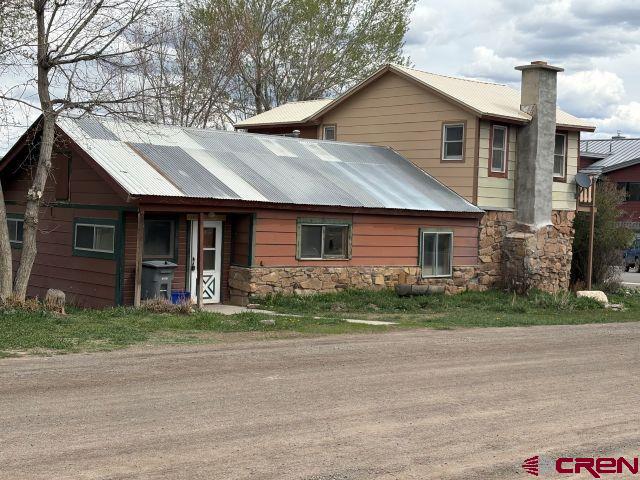 Great opportunity for investment or your personal property on a corner lot in Ridgway.  Zoned residential with Town of Ridgway water, Town of Ridgway sewer, Black Hills Natural gas and San Miguel Power .  3 bed/2 bath on a corner lot, 2-Car detached garage and a separate office/outbuilding.  Superb views of the Cimarron Mountain Range.  Close to all the amenities of the Town of Ridgway including, but not limited to:  Town Music in the Park, P.O., Grocery Store, Restaurants, and Library.  The home is south facing with a low maintenance outer materials:  rock, metal and masonite.