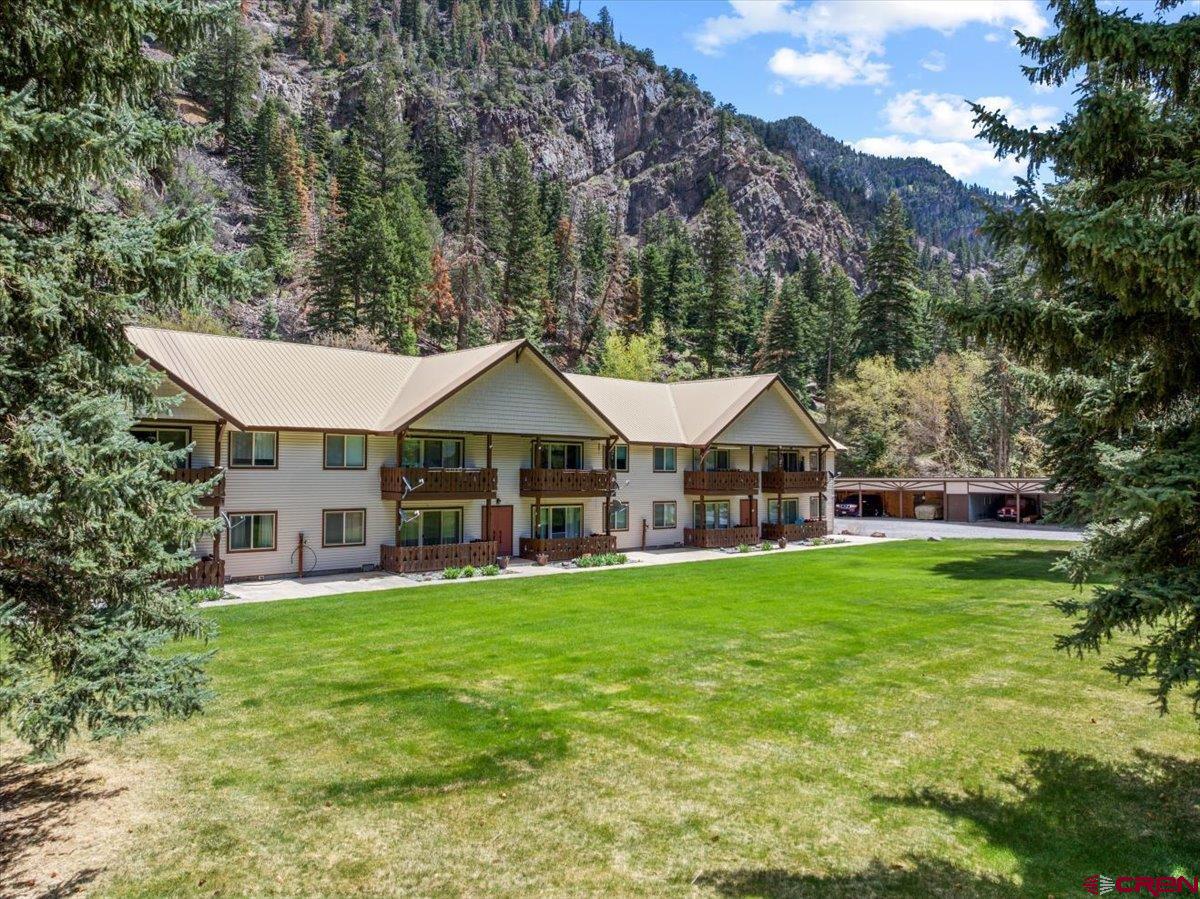 Welcome to affordable!This is a beautifully kept condominium at the north entrance to the City of Ouray. Surrounded by exquisitely carved canyon walls and a show stopping lawn area in the front complete with towering pines, the building could not be more conveniently located! This is a second floor unit - no noise above you! Elevated, with beautiful views of the canyon and the trees, it is your own personal tree house. Warm and comfortable with two bedrooms, a living room, cozy kitchen plus a deck overlooking the grass area. Being on the second floor, the R-49 insulation in the ceiling is an added bonus! This is a perfect "lock and leave it" situation if you are not in residence all year long. Easy upkeep allows more time to enjoy the Hot Springs Pool, shops and restaurants that make Ouray so special. Skiing, hiking, jeeping and exploring all combine in this unforgettable part of Colorado and this unit allowsi you to take advantage of all of it.