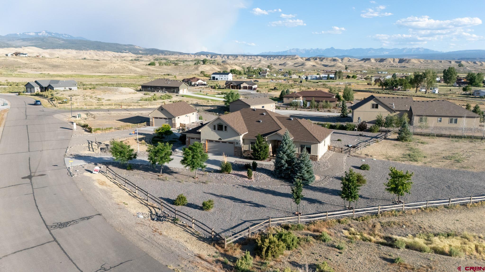 Experience refined Colorado living at 69072 Oak Grove Rd, where 1.5 acres of beautifully usable land, sweeping mountain and valley views, and exceptional functionality come together to create a truly special property. From sunrise over the peaks to golden Colorado sunsets, the scenery here is nothing short of breathtaking, providing a stunning backdrop in every direction.  Inside, warm hardwood floors, abundant natural light, and a thoughtfully designed floor plan create an atmosphere that feels both welcoming and sophisticated. With 4 bedrooms plus a bonus room, there is plenty of space for family, guests, a home office, fitness room, or creative pursuits.  What truly distinguishes this property is its incredible combination of lifestyle and practicality. Car enthusiasts, hobbyists, and outdoor adventurers will appreciate the impressive garage and storage setup. The attached 3-car garage is complemented by a detached 2-car garage featuring dedicated workshop space in the rear and substantial storage above, offering endless possibilities for projects, equipment, seasonal storage, or a home-based business. Combined with the expansive driveway, there is ample room for up to 5 vehicles, RVs, trailers, recreational toys, and guests.  The greenhouse adds another layer of versatility, allowing for year-round gardening and a more intentional connection to the land. Outside, the covered patio serves as an extension of the home, inviting you to entertain, relax, and fully embrace the spectacular views and peaceful surroundings.  Set in a quiet, desirable neighborhood that feels private and serene, yet remains conveniently close to Montrose amenities, this property offers the perfect balance of space, luxury, and everyday functionality. With its acreage, incredible mountain views, extensive garage and workshop space, and thoughtful design, this is Colorado living at its finest.