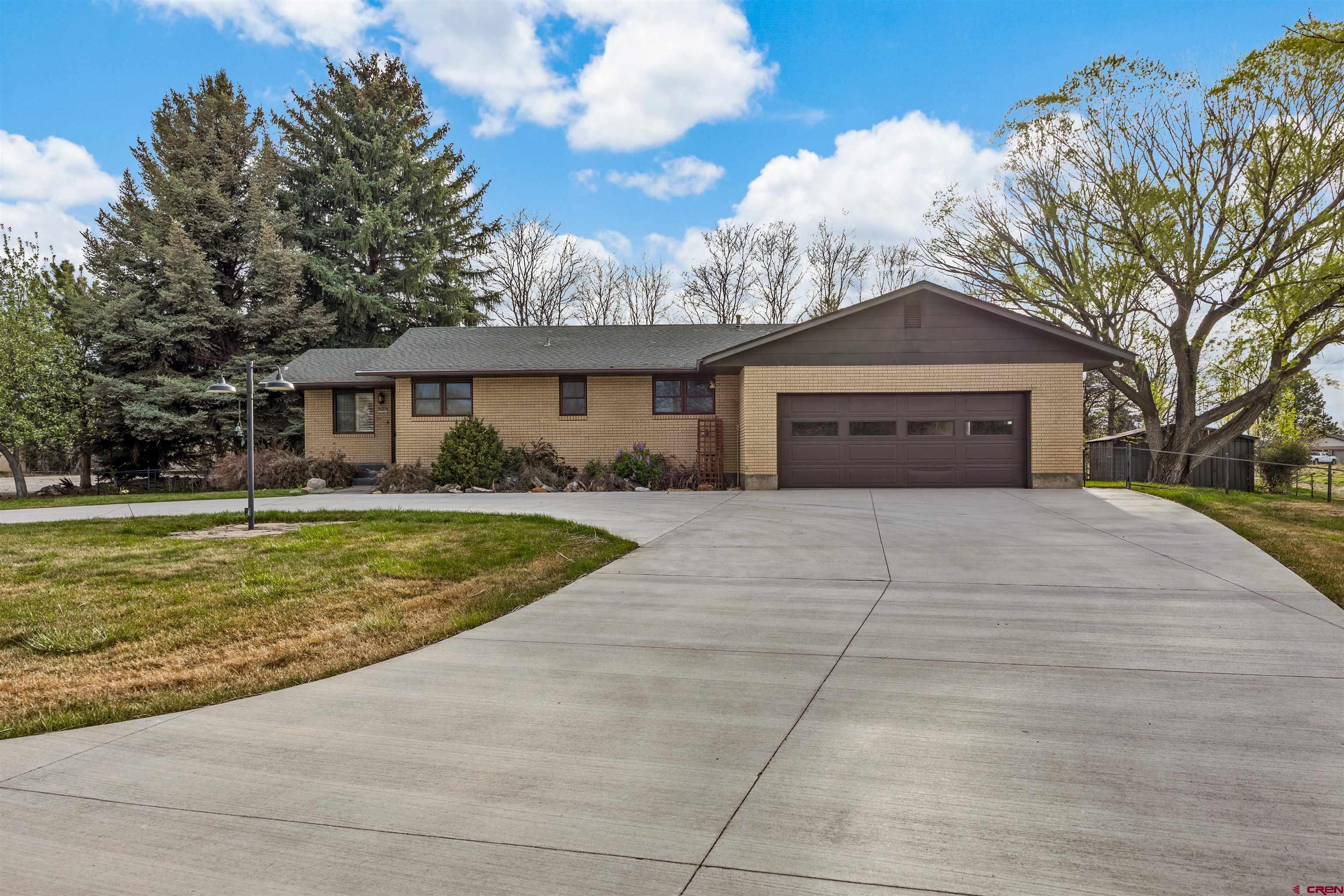 Thoughtfully Updated Brick Home on Acreage with Shop & Outbuildings. Set on nearly 2 irrigated acres just minutes from town and close to National Forest access, this remodeled 1969 brick home offers the perfect blend of functionality, flexibility, and country lifestyle.      Inside, you’ll find an updated interior with a primary suite conveniently located on the main level, along with comfortable living spaces designed for everyday ease. The finished basement expands your options with additional bedrooms and a separate exterior entrance—ideal for guests, multi-generational living, or potential rental income.      This property truly shines for those who need space to work, store, and create. A 30x40 shop—previously used by an automotive enthusiast—provides an excellent setup for projects or business use. In addition, you’ll find a large quonset-style storage building and a substantial pole barn, offering ample room for equipment, vehicles, or recreational toys.    The land itself is a standout feature—nearly 2 acres with irrigation water, a well, and mature trees and landscaping that provide shade, privacy, and a sense of established beauty that takes years to achieve.      Whether you're looking for room to spread out, space to pursue your hobbies, or an opportunity for supplemental income, this property delivers it all—with the convenience of town just minutes away and the outdoors right at your doorstep.