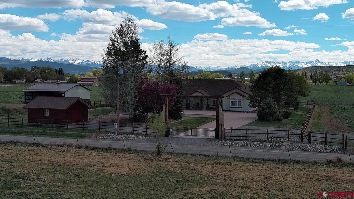 This spectacular holding is a Montrose County gem- featuring a rural locale, huge view corridor, 14 irrigated acres, equestrian facilities (40x36' barn), and a magnificent 3,609 SF, 4-bed / 2.5 bath, home. With the entire San Juans, from Sneffels to Potosi, splayed above irrigated hay land, the home feels like rural Colorado, yet maintains a 5-minute commute to town. Whether it be the wood rail fencing and log gateway or the split floor plan and open kitchen (featuring granite countertops and custom alder cabinets) this is a well thought out and meticulously maintained home. The roof was completely re-shingled 2 years ago, the hardwood floors are immaculate, and everything is “move in ready.” From working in the his/her’s offices, entertaining in the great room, relaxing in the den, or sipping coffee on the south facing porch, this estate is a treasure in, and of, itself.