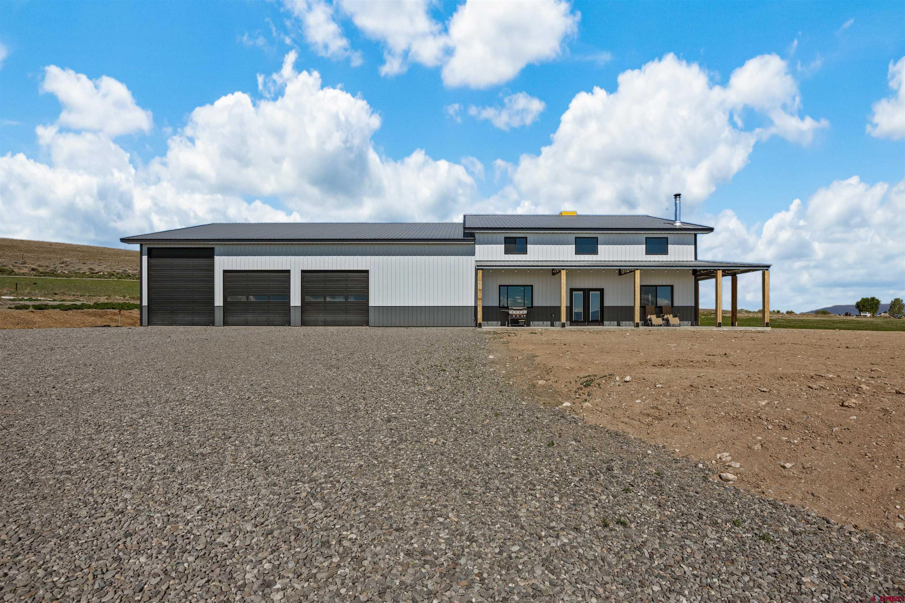 Modern Barndominium Living on 6 Irrigated Acres     This fully customized barndominium was thoughtfully built with insulated walls and floor for enhanced sound control and energy efficiency creating a quiet, comfortable living environment you can feel the moment you walk through the front door.    Inside, the home opens to a classy and warm living space featuring in-floor radiant heat throughout, complemented by a cozy wood stove that anchors the heart of the home. The kitchen is fabulous with quartz countertops, a large farmhouse sink, abundant custom cabinetry, under-cabinet lighting, and a dedicated coffee bar that adds a personal touch to your daily routine.    Lighting has been elevated to another level with adjustable LED systems offering five color tones and dimmable settings, allowing you to create the perfect ambiance from bright and energizing to soft and relaxed.    Upstairs, a versatile loft provides the ideal flex space—currently used as an office but easily adaptable to fit your lifestyle. Step outside and the functionality continues with a 50’ x 60’ insulated shop, built with an additional layer of insulation for an enhanced R-value and equipped with in-floor heat and a wood stove—making it a year-round workspace or storage solution.    The property is fully equipped for rural living with 6 irrigated acres, plus added conveniences including an RV hookup and a dedicated RV dump connected directly to the septic system.    Tucked into a peaceful and serene setting, yet just minutes from town, this property offers the perfect balance of privacy, practicality, and modern rural living.    Barndominiums of this caliber—combining craftsmanship, efficiency, and lifestyle—are increasingly sought after and rarely available. Contact agent today for a detailed feature sheet and to schedule your personal private showing.