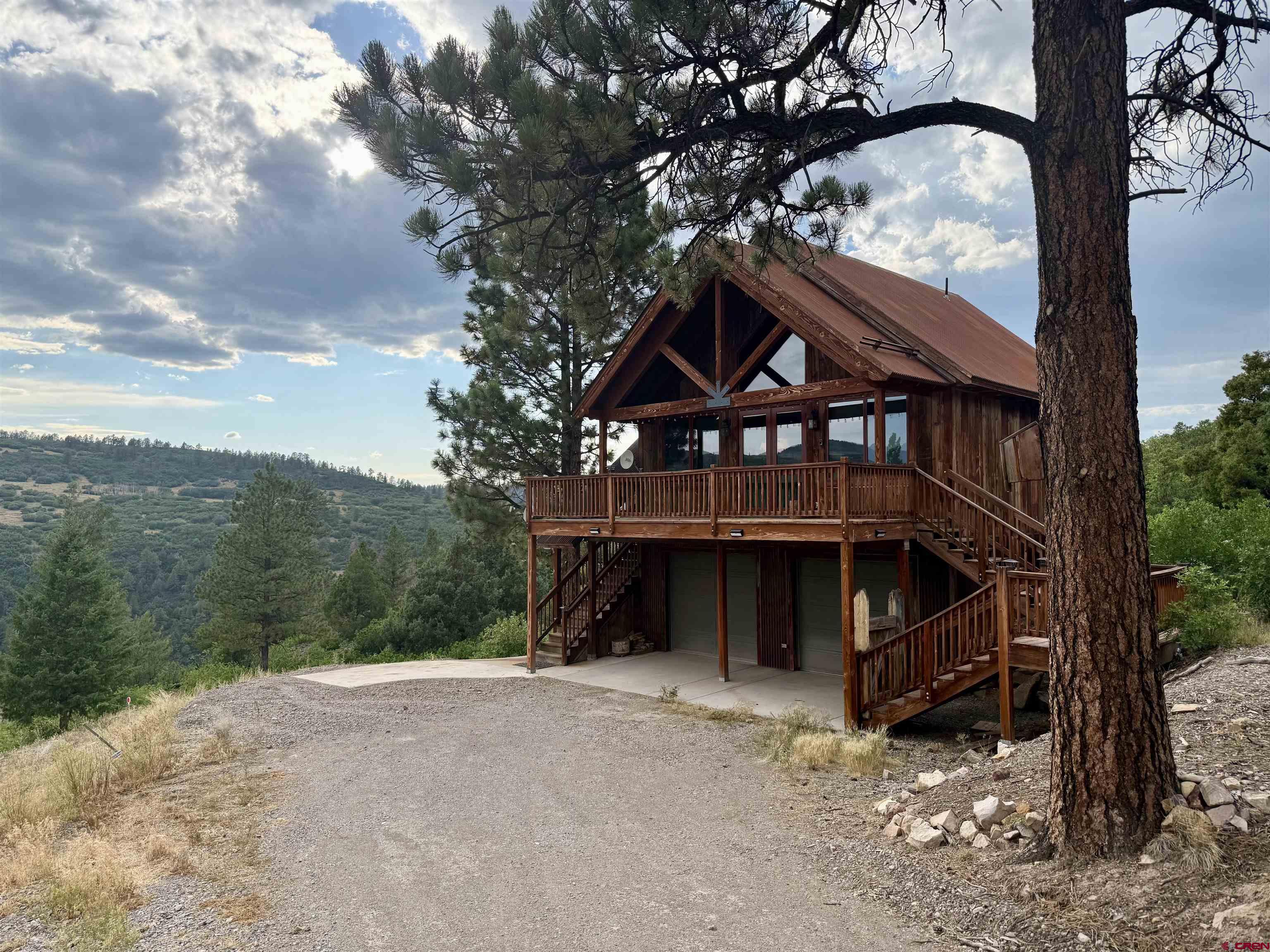 Modern mountain living meets big alpine views in this beautifully designed 1,000 sq ft retreat in the Telluride Pines subdivision near Placerville on 5 acres. This thoughtfully crafted two-bedroom, one-and-a-half-bath home captures stunning vistas of Mount Wilson and Hastings Mesa. Barn wood exterior, clean lines, and an efficient layout create a comfortable yet stylish interior, ideal for full-time living or a mountain getaway. Step outside onto the expansive south-facing deck perfect for soaking in sunshine, entertaining guests, or simply enjoying the breathtaking scenery year-round. In-floor, radiant heat, and engineered wood throughout with tile in the bathrooms adds to the warm finishes.The property offers exceptional flexibility with an additional engineered and inspected foundation already in place. Whether you envision building a larger main home, expanding outdoor living space with a custom deck, or adding a workshop, the groundwork is done. The septic system has been fully prepared to accommodate the additional structure, saving time and expense. A rare opportunity to own a turnkey home with room to grow, all set against the dramatic backdrop of Colorado’s San Juan Mountains just 25 minutes to Telluride and 25 to Ridgway.