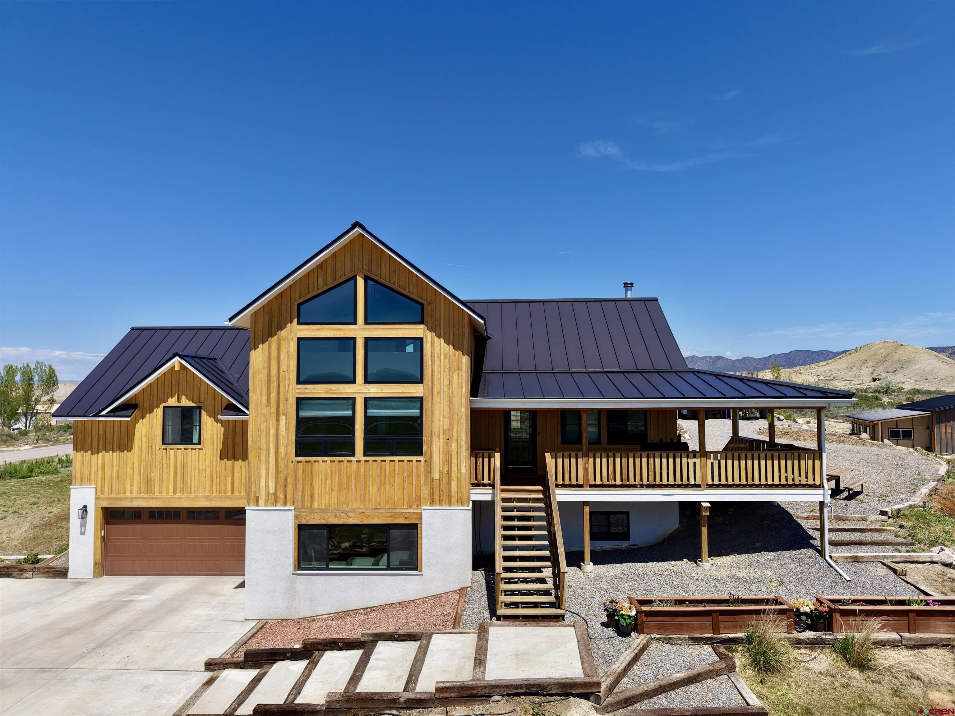 Take a look at this rare opportunity with unparalleled and unobstructed mountain views! This stunning custom 4-bedroom, 3.5-bath home offers ~3,104 sqft of quality living space on a 2-acre parcel right at the edge of city limits with no HOA or covenants. Built on an energy-efficient ICF foundation with a unique design and craftsmanship…this definitely isn’t your cookie-cutter home. As you approach the property, you can’t help but note the impressive curb appeal from the high-end standing seam metal roof up top down to the stylish and timeless fir board and batten siding. Inside, you’ll find beautiful Southern yellow pine wood floors coated in a rich WOCA European oil finish and stylish black Andersen windows throughout. The kitchen impresses with flush-mount walnut cabinetry, stainless steel appliances, two large pantry spaces, a massive island and dining area that maximize the mountain and valley views to the south out of the gable windows and also provide the welcomed solar gain in the winter months. Cozy up by the wood-burning stove in the living room, or retreat to the expansive loft suite offering its own zone for climate control via a dedicated mini-split, an ensuite bathroom, walk-in closet, and continued theme of big southern views. On the main level, in addition to the kitchen and living room, you’ll find a full bath with a distinctive Venetian plaster along with two bedrooms and an additional powder room for guests off the living room. The fully finished daylight basement includes two more bedrooms, a full bath, and a second living area which is ideal for guests, extended family, home office, or whatever your needs may be. From the basement, you have direct access to the front of the home via an exterior door or directly into the attached 2-car garage that’s insulated and plumbed for a gas heater if you want to add one. Don’t forget the outdoor living as it’s exceptional here! A 2-acre lot with a retention pond filled via shared irrigation water allows for easy watering and the flexibility to garden or landscape as you please. There is a 4-zone system in place to water the grass areas already. A 22’×42’ metal RV carport is tucked at the back of the property to protect your equipment, trailers, toys, vehicles, or whatever you need to keep out of the beautiful but strong Colorado sun. The massive 30’×40’ detached shop is lofted at the back half, and the building provides a perfect balance of space to maximize utility. A large concrete floor area allows you to work, store things, participate in your hobbies, or simply gather with friends to kick back and enjoy the views out the sliding doors. The shop is partially insulated and has a wood-burning stove for year-round comfort. The east side has a 12’×40’ lean-to, and the west side has an enclosed 12’×32’ workout room. This property is one of a kind and combines rural peace with city convenience. Don’t miss the chance to own this stunning property where you’ll never have to worry about losing your mountain views again…call to schedule your private showing today!