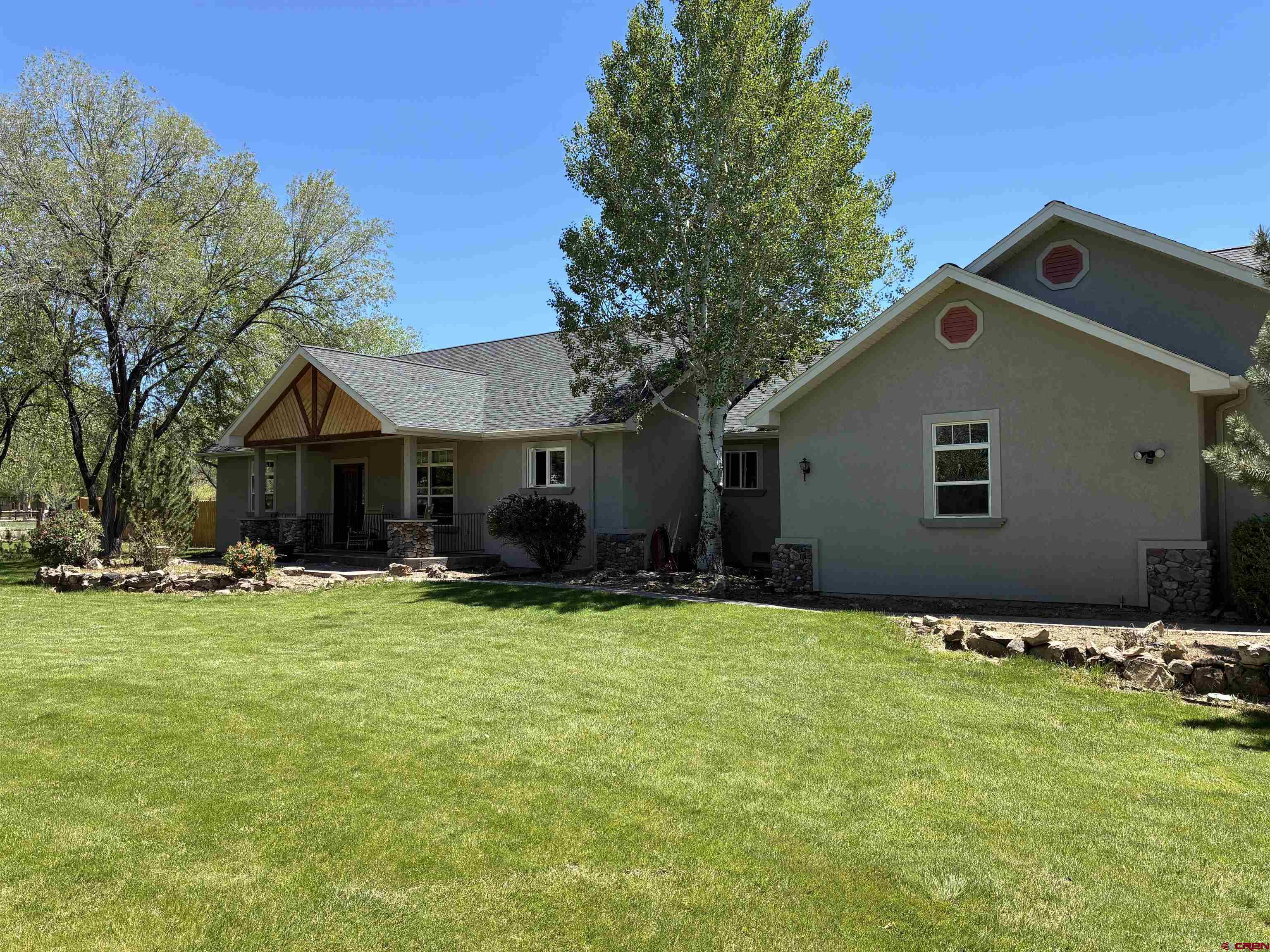 Experience the rare combination of space, privacy and convenience in this exceptional home in Montrose Colorado. Situated on nearly 1.5 acres just off East Main Street, this beautifully maintained 2,880 square foot single-story residence offers a setting unlike any other in town. Tucked away on a quaint cul-de-sac with only two neighboring homes, the property provides both tranquility and easy access to local amenities.  Inside, you will find a thoughtfully designed layout featuring three spacious bedrooms and two full bathrooms, a dedicated office, and a bright sunroom/fitness room just off the primary suite. The primary bedroom is complete with two walk-in closets, creating a private and functional space to relax and unwind. An oversize garage gives room for vehicles and the fun toys.  The heart of the home is the expansive kitchen equipped with a large island, double wall ovens and a gas range, perfect for preparing meals and gathering with friends and family. The generous living and dining areas flow seamlessly from the kitchen, offering ample room for entertaining or relaxing. Home had a new roof installed April 2026.  Head outdoors and the 1.5 acre property truly shines. A large pond provides irrigation for the entire grounds, while mature trees, lush lawn areas and a dedicated garden space create a peaceful, park-like setting. Cedar Creek borders property and flows year-round bringing a wonderful peaceful sound. Enjoy Colorado’s beautiful seasons from both the front and rear patios, ideal for morning coffee or evening gatherings. A substantial 24’x12’ shed offers abundant storage for tools, equipment, and recreational gear.  This is a rare-opportunity to own distinctive property that blends space, comfort and natural beauty, all within the city limits of Montrose.  One not to be missed.