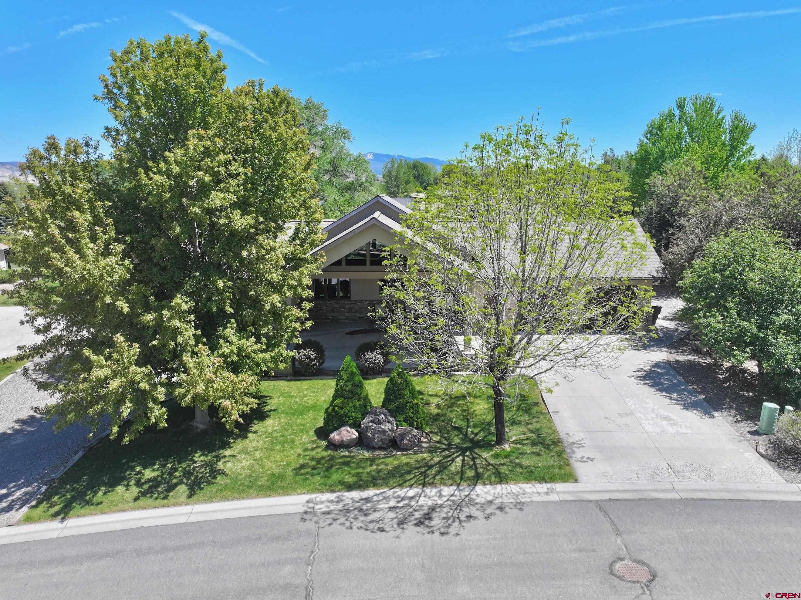 Luxury living with serene pond views in the highly sought-after Brook neighborhood! Conveniently located near the new community recreation center, shopping, dining, and top-rated schools, this stunning home blends elegance with everyday comfort.  Designed for entertaining, the spacious floorplan features soaring ceilings, oversized windows, gleaming hardwood floors, and an executive chef’s kitchen with granite countertops, stainless steel appliances, cherry cabinetry, and a walk-in pantry. The formal dining area opens to a large covered deck overlooking the neighborhood pond, creating the perfect indoor-outdoor living space.  The main level includes a private office, luxurious primary suite with dual closets and a spa-like bath, a guest suite with full bath, and a well-equipped laundry room with sink. Downstairs, you’ll find a large second living area, two guest bedrooms connected by a Jack-and-Jill bath, abundant storage, and a walkout patio with a wired hot tub area. Outside, enjoy beautifully landscaped grounds with mature cottonwoods, fruit trees, lush lawn, and direct access to HOA common space. The attached three-car garage includes an extended bay ideal for a workshop or gym, plus extra attic storage and an impressive Porte-Cochère for additional covered parking.  Most furnishings are negotiable.
