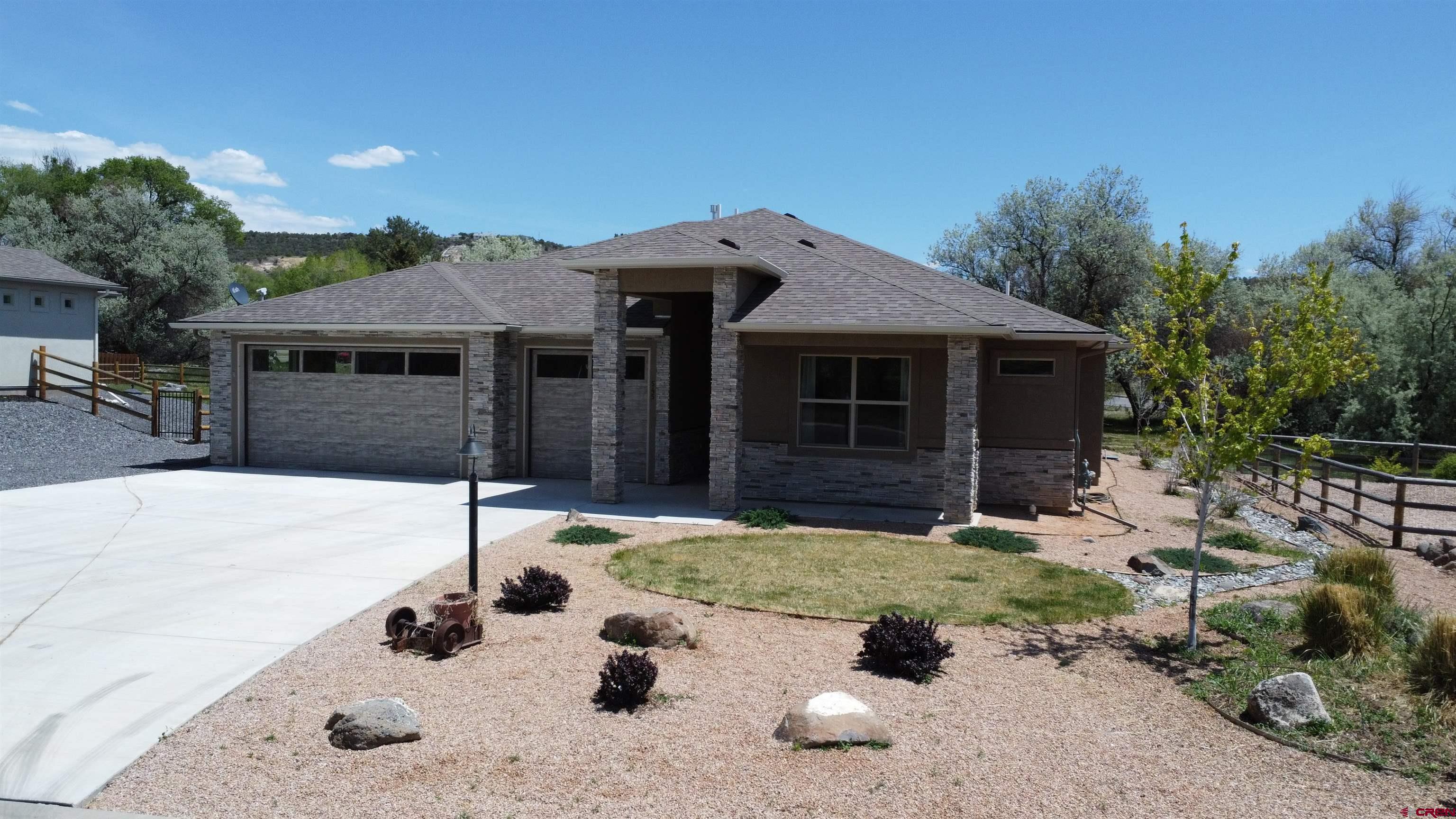 A 2,100 sq. ft. single-story home featuring high-quality finishes including wood frame, stone, and stucco materials. The interior offers a spacious 3-bedroom, 3-bathroom floor plan designed for comfortable one-level living.  Situated on 0.31 acres, the property features a paved driveway and an attached 3-car garage, providing ample space for vehicles and storage. The home is designed with an open-concept feel, highlighted by vaulted ceilings and plenty of natural light. A chef-ready kitchen includes a center island, granite countertops, a pantry, and high-end appliances (range, dishwasher, disposal, and microwave). Features a private walk-in closet and a 6 piece primary bathroom with a walk in shower.  Includes a dedicated mudroom and a mix of central air and ceiling fans for climate control. Built in 2023, the home is newer and well maintained and sits within the Cedaredge Golf Club neighborhood.