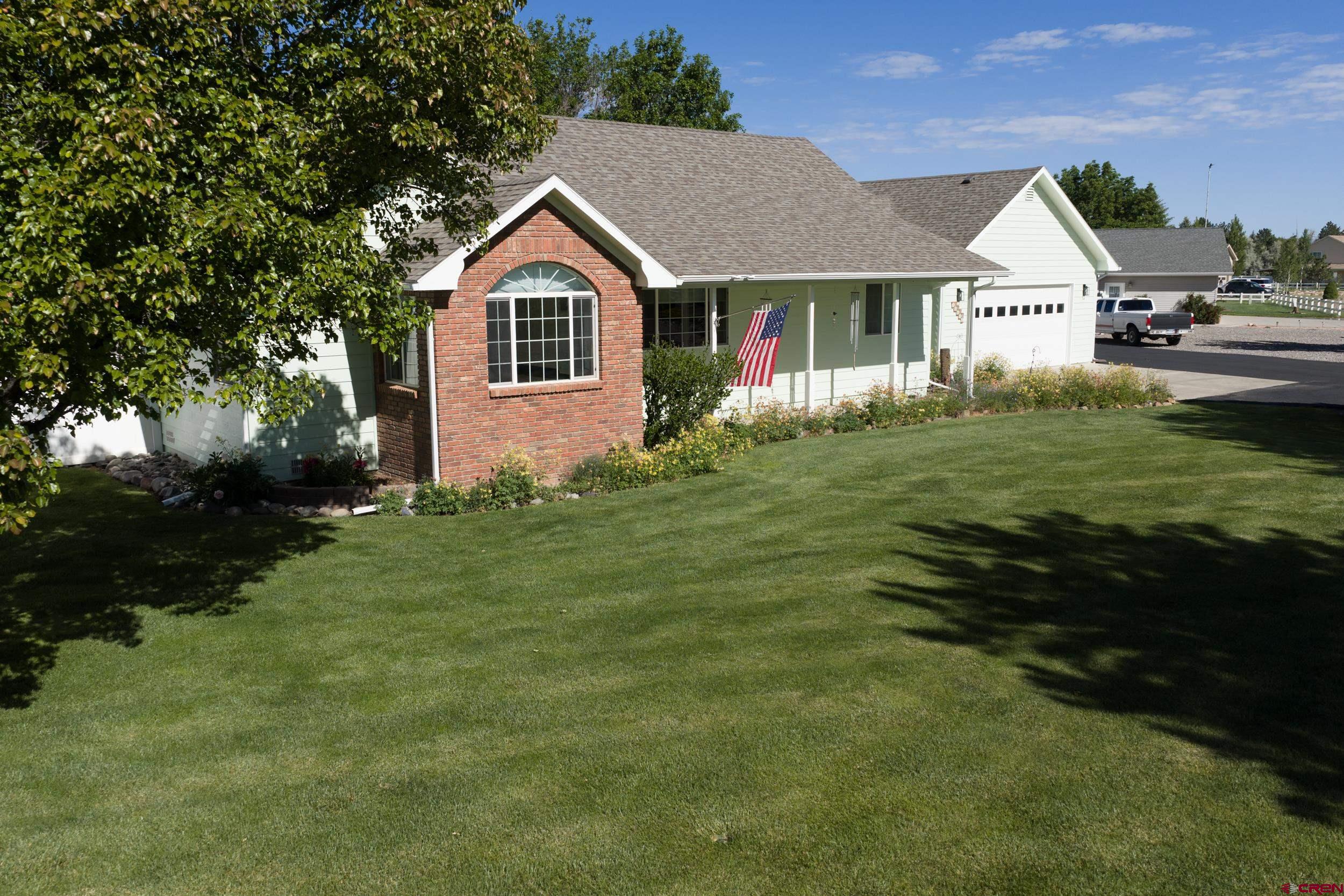 ** PRICE REDUCTION **   Easy to Show and move-in ready Western Colorado paradise on a beautifully maintained 1-acre lot!  This unique property features a 2-car attached garage PLUS a 2-car detached garage equipped with electricity, attic storage, and a 30-AMP camper hookup. The pristine, expansive acreage is easy to maintain with HOA irrigation water, featuring a wide drive-through gate and a storage shed. Enjoy outdoor living from the covered front porch, back deck, or separate patio. Inside, the spacious kitchen boasts an apron sink, breakfast bar, butler’s pantry, and gas range. Cozy up to the wood-burning stove or retreat to the primary suite with its large, tiled walk-in shower. Boasting a brand-new roof, new gutters, fresh exterior paint , this turnkey estate is a rare find. Bonus: Enjoy exclusive, breathtaking private neighborhood access to the Uncompahgre River!  Reminder - Sellers had Pre Home Inspection and have made all repairs noted by Inspector. Report is available to share with qualified buyer agent.