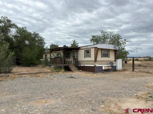 Two bedroom, 1 bath manufactured home faces the beautiful Grand Mesa, also providing fantastic sunset views. Home needs some TLC, so come take a look and bring your imagination with you to either fix up the current manufactured home or remove and replace with the home of your choice.  There is irrigation through OCID.  The amount is being verified with the water company.  Irrigation has not been used in several years.