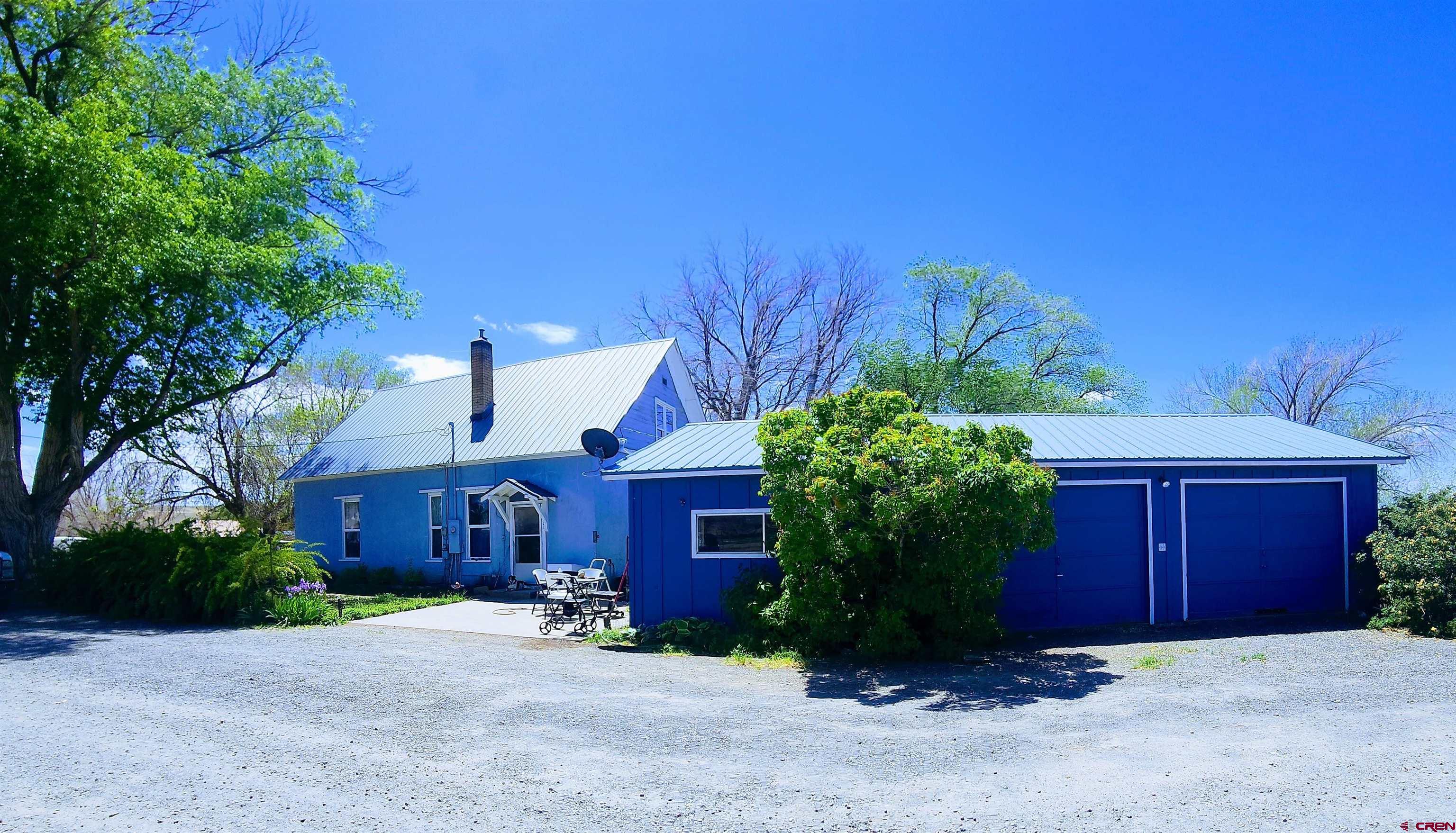 COUNTRY CHARM WITH ENDLESS POTENTIAL ON NEARLY 4 ACRES! If You’ve been Searching for an Affordable Acreage Property with charm, Location and Lots of Potential, here’s Your Chance to Invest in a Country Property where Hard Work and Imagination can Truly Pay Off! This Sweet Property is Nestled in a Pretty Country Setting surrounded by Large Shade Trees. Even though the address is Highway 65, it is way back off of that road on a private lane, so the setting is very quiet. Horse Lovers and Hobby Farmers will Appreciate the Property’s Excellent Setup, complete with a Barn with Separate Pens, a Large Arena Area and Ample Space for Additional Agricultural Pursuits with Room for Horses, Livestock, Gardening and More. Includes Large Farmhouse and a great 2-Car Garage & Workshop. It has Natural Gas Hot Water Baseboard Heat and a new Septic System that was installed in 2023. While the Home & Grounds do Require Plenty of TLC and Repairs for Deferred Maintenance, this Offers the Ideal Foundation for a Country Lifestyle at a Great Price!