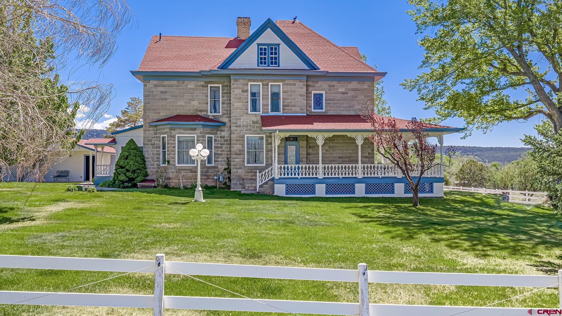 Historic 5-bedroom, 3-bathroom, 2,800 sq. ft. victorian "Stolte House", rich in Cedaredge history and surrounded by irrigated hayfields with stunning San Juan Mountain and Grand Mesa views is up for sale! This unique property is being offered with 40 acres featuring quality irrigation water and potential for future development or subdivision. Improvements include a 50x50 conditioned shop with a half bath, a 3-bedroom, 2-bath ADU for guest living or additional rental income, and a good-producing irrigation well that helps keep the grounds lush and productive.  The property is extremely versatile and can be utilized in a variety of ways. Live in the historic Victorian and rent the ADU, rent both for income potential, or create the ideal setup for horses, livestock, or a small agricultural operation. Gated pipe delivers irrigation water, and gravity-fed irrigation supports hay production while helping maintain agricultural tax status.  Listed on the National Historic Registry, the main home offers all the charm and character expected, with original woodwork and historic features largely unchanged. Additional features include a large basement for utilities and storage, a freshly painted exterior, and the freedom of no HOA and no covenants. A rare opportunity to own a piece of Cedaredge history with acreage, income potential, and endless possibilities.