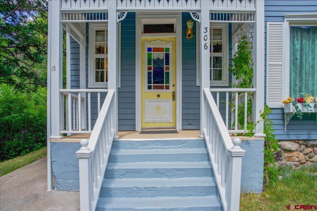 Charming Victorian cottage with expansive Amphitheater views! This quaint Victorian home is filled with timeless character and sits on the hillside above the Uncompahgre River on the west side of town. Warm and inviting, the home features a cozy wood stove, classic clawfoot tub, and large windows that frame the stunning scenery—perfect for relaxing and taking it all in. Enjoy the soothing sounds of the river below and Oak Creek nearby, creating a peaceful mountain retreat. Recent updates include new windows in most of the home, a new roof (2025), new mini-split systems for efficient heating and cooling, fresh exterior paint, and a hot water heater replaced approximately three years ago. Offered furnished, this turnkey property is ready for you to step in and make it your own. Call for your showing today!