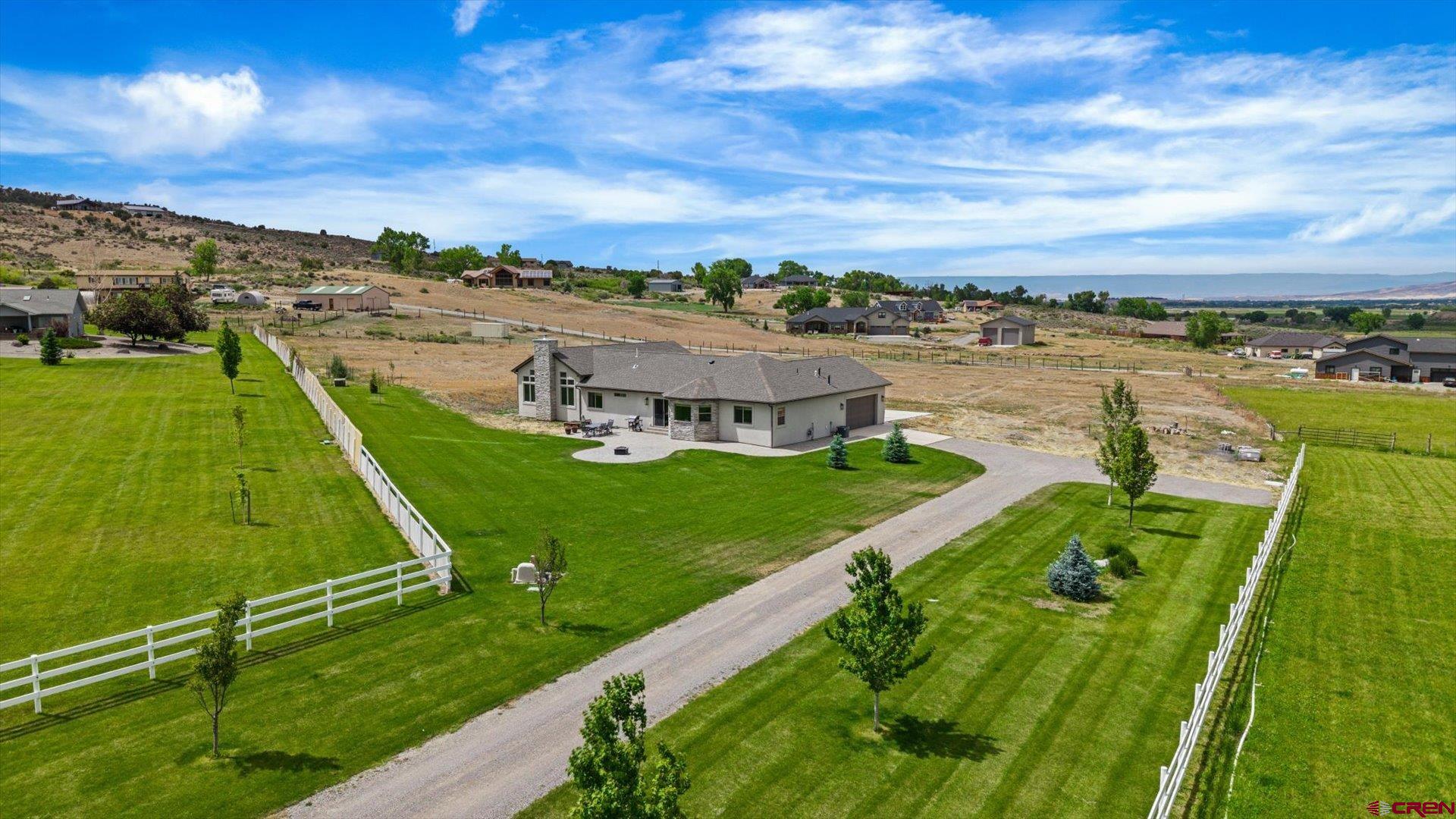 Spectacular Custom, Ranch Home on 3+ Irrigated Acres with Majestic Mountain Views, 2 En-Suites, Gorgeous Finishes, And In An Unmatched Location! An exclusive invitation to call the beautiful, rolling greenery of Ducket Draw your home, tucked on the end of a cul-de-sac, complete with everything that makes living in Western Colorado so good. A newer construction and completely custom creation, this home features everything from high-quality finishes to an extremely versatile floor plan. Step inside to an open layout, perfect for hosting loved ones and giving them a hospitable and excellent experience. Engineered hardwood floors delivering character and warmth, pristine quartz countertops elevating the atmosphere, and custom-crafted, soft-close cabinetry bringing another level of functionality and enjoyment. The kitchen has an ergonomic layout, on-trend tile backsplash, stainless appliances, and great natural light. Have multi-generational living needs, frequently have guests over, or just young ones needing their own space? 2 en-suites brings all these possibilities into view and provides for all of your needs. Enjoy also a secondary living room, complete with massive windows, a huge stone fireplace, and all the ambience in the world. Make this space the perfect spot for gatherings with your loved ones, the ultimate work-from-home office, an epic library/reading room, or the home gym of your dreams. Functionality continues in a massive, dedicated laundry/utility room, with durable and trendy tile floors, a stainless commercial grade sink, and great windows bringing in natural light, making the everyday tasks of life easy and enjoyable. An additional mudroom allows you to keep the mess out of sight, and the oversized garage would accommodate larger vehicles with ease. Step outside to multiple patio/entertaining areas, each featuring unique and inspiring views from the Cimarron Mountain Range to Black Canyon National Park. An expanse of possibilities exist in the 3+ acres, including constructing a detached shop garage or additional home, enlarging the yard and creating a backyard oasis, or just keeping it as natural buffer and privacy from the chaos of the outside world. Discerning yet relaxed covenants ensure value protection, while preserving freedom and beauty all around you. Finding a property that delivers a sprawling, newer construction gem on this acreage with these views and these possibilities is like trying to find a needle in a haystack. Allow Us to Introduce You to 65414 Sunridge Court; Experience it For Yourself Today!