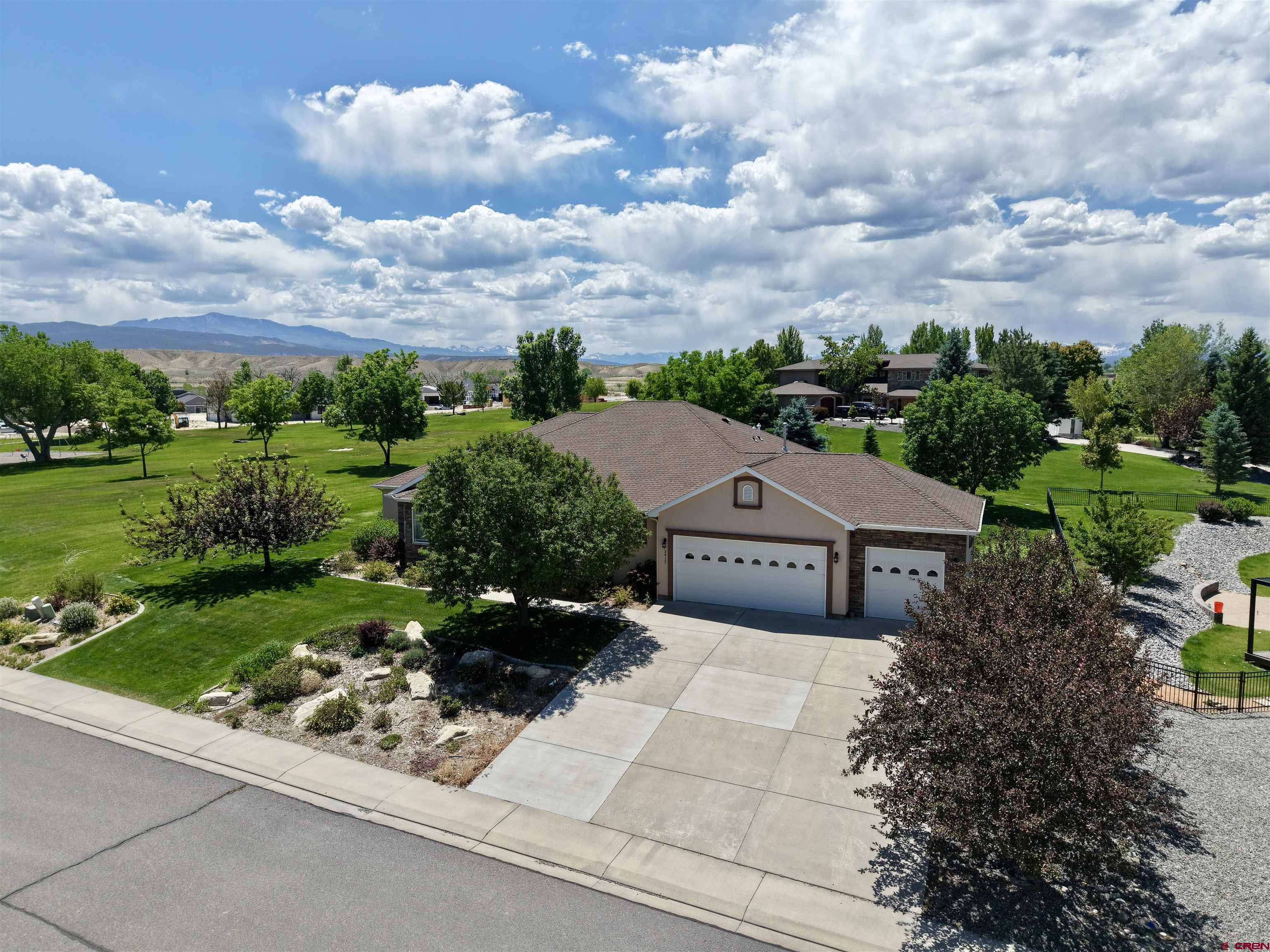 Perfectly positioned on a generous .41 acre lot, this exceptional ranch style home enjoys one of the most desirable settings in Brown Ranch. Located immediately adjacent to the subdivision park and backing to a fully landscaped vacant lot, the property offers a rare sense of privacy and open space, creating the feeling of having your own park right outside your back door. Designed with a spacious split bedroom floor plan, the home features a welcoming living room highlighted by a coffered ceiling and a large picture window that frames the beautiful backyard views. Both formal and casual dining areas provide flexibility for entertaining and everyday living, while the expansive kitchen offers a center island, breakfast bar, abundant cabinetry, and a complete appliance package, including the washer and dryer. The oversized primary suite includes a 5 piece en suite bath and a large walk in closet. Two guest bedrooms are connected by a convenient Jack-and-Jill bath, plus there is a nice office with bay window, and additional hallway storage cabinets provide practical organization throughout the home. A large laundry room includes extra closet space and a convenient half bath. Car enthusiasts and hobbyists will appreciate the oversized 3 car garage featuring a utility sink, attic storage, and an overhead rear garage door for easy backyard access. Additional amenities include forced-air natural gas heat, central air conditioning, and a heated driveway. Ideally located within the highly sought-after Brown Ranch subdivision, this home is just minutes from Montrose's south-side shopping, dining, and the Montrose Recreation Center.  Original owner.