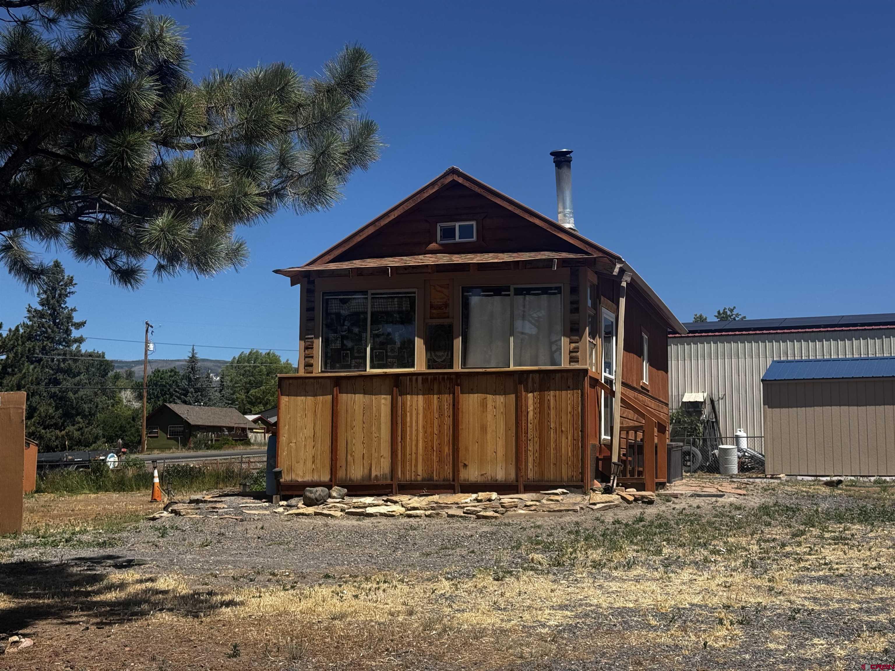 Outstanding corner lot opportunity in Cedaredge! This 0.34 acre parcel offers excellent visibility, easy access, and a desirable in town location. The property already features a finished 392 sqft studio with loft, providing immediate usable space for an office, studio, workshop, storage, or a variety of other potential uses. Utilities are all to the property but need purchased and hooked into. Large storage shed also comes with it. Positioned near downtown shops, restaurants, and community amenities, the property presents exciting possibilities for commercial, mixed use, or investment development, subject to zoning requirements. A rare opportunity to secure a prominent lot with existing improvements available in the heart of the Surface Creek Valley.