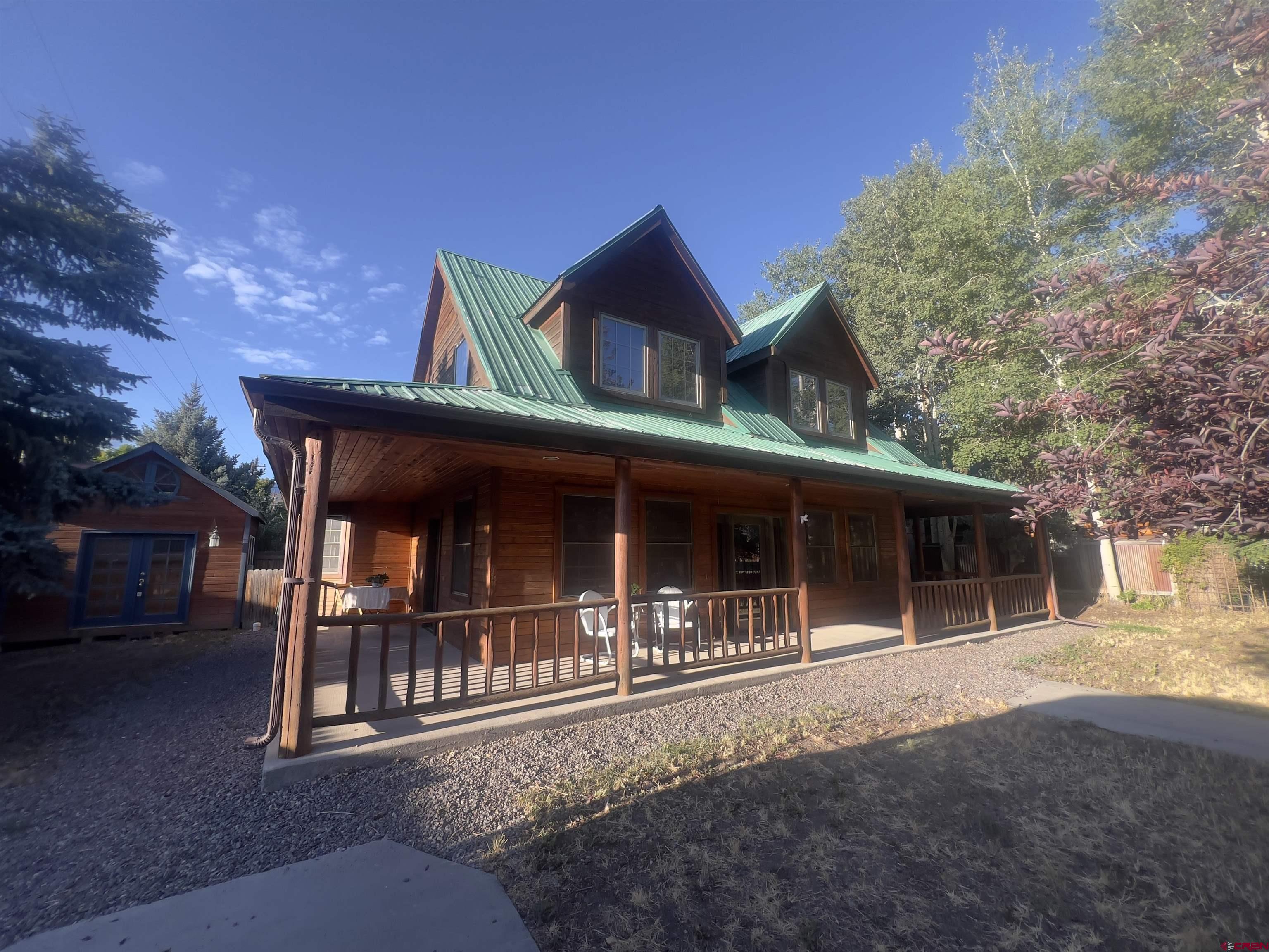 Looking for a single-family home in Ridgway, Colorado priced like a condo? This is a rare opportunity to enjoy standalone living on a quiet street—complete with a private yard, dedicated parking, and flexible bonus space—while staying within a similar price range often seen in the condo market. This 2-bedroom, 2-bathroom Ridgway home offers comfort, functionality, and versatility. Inside, you’ll find warm wood floors, abundant natural light, and an impressive amount of storage with multiple closets throughout. A full-length covered front porch extends your living space outdoors—perfect for morning coffee, evening unwinding, or taking in Ridgway’s peaceful surroundings. The property includes a separate studio space, ideal for a home office, artist studio, workshop, or wellness retreat. Whether you’re building a business, creating art, or simply need a quiet place to reset, this flexible space adapts to your lifestyle. Outside, mature trees provide shade and privacy, while the driveway offers room for your Colorado toys—rafts, bikes, or motorcycles. A detached storage shed keeps gear tucked away and organized. Located just minutes from the heart of town, this home is walkable and bikeable to Ridgway amenities, including the library, park, post office, and historic Clinton Street. Enjoy easy access to the Sherbino Theater, local restaurants, shops, and art galleries that define Ridgway’s vibrant community. Outdoor recreation is right outside your door. The Ridgway Area Trails (RAT), river trail, and hiking paths are all nearby. Cool off with a dip in the river, or take a short drive to nearby hot springs to relax and recharge. Ridgway is a designated Dark Sky Community, meaning you’ll enjoy breathtaking stargazing right from home—small-town living without sacrificing natural beauty. Need more amenities? The town of Montrose, with its regional airport, shopping, and services, is an easy drive away. If you’ve been searching for an affordable Ridgway home with space, flexibility, and lifestyle appeal—this is it. Live simply. Live locally. Live Ridgway.