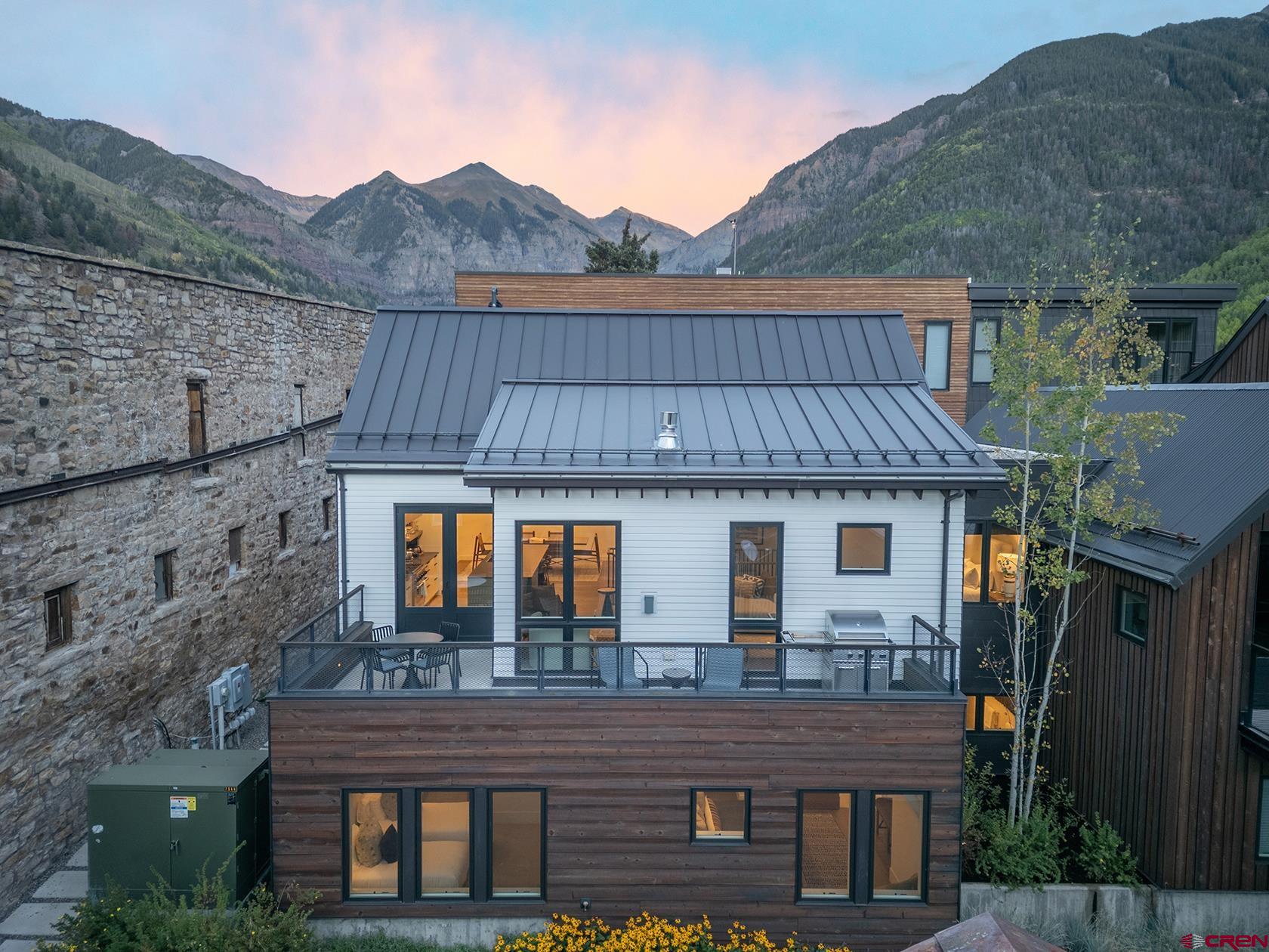 It doesn't get much better than this. Located in the heart of Telluride, just one block from the gondola and Main Street, Loft House 102 offers the perfect balance of mountain luxury, convenience, and comfort. This Mountain Modern residence lives like a single-family home, with 2,570 square feet of thoughtfully designed living space featuring four bedrooms, five full baths, and a spacious loft--ideal for gathering with family and friends after a day on the slopes or trails. Beautifully appointed and offered fully furnished, the home is truly turnkey, complete with custom closet build-outs, all electronics, TVs, speakers, and a Sonos sound system. White oak floors, custom cabinetry, air conditioning, and quality finishes throughout create a warm, inviting mountain retreat, while the  spacious deck is the perfect place to unwind and take in spectacular Telluride sunsets.  The amenities at Transfer elevate the experience even further, including a private fitness center, ski and boot locker room with boot dryers, custom dry sauna, heated garage parking, and a large private storage closet.  The location is hard to beat. Walk one block to the gondola for effortless access to world-class skiing and Mountain Village, stroll into town for coffee, shopping, dining, and après, or head just three blocks to Town Park for Telluride's legendary summer festivals and concerts. Close enough to enjoy everything Telluride has to offer, yet tucked away from the hustle, this home offers the best of both worlds.  Whether you're searching for a mountain getaway, a full-time residence, or an exceptional investment, Loft House 102 delivers. With a proven, strong rental history and one of Telluride's most sought-after in-town locations, this is a rare opportunity to own a home that embodies the very best of the Telluride lifestyle.