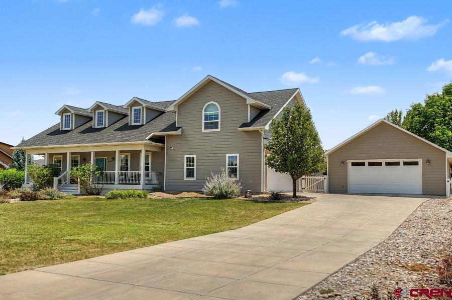 A rare opportunity to own a beautifully appointed home in one of the area's most sought-after neighborhoods! Perfectly positioned to capture breathtaking views of the community pond and water features, this exceptional property offers the perfect blend of luxury, comfort, convenience, and outdoor living.  From the moment you arrive, you'll appreciate the inviting covered front and back porches, mature trees, professional landscaping, and the fully fenced backyard designed for both relaxation and recreation. Garden enthusiasts will love the large raised-bed garden with irrigation, potting shed, and the open greenspace beyond the property where deer are frequent daily visitors. A beautiful brick patio provides the perfect setting for outdoor entertaining.  Inside, thoughtfully designed living spaces feature elegant countertops, designer fixtures, beautiful flooring, and a warm gas fireplace anchoring the great room. The well-appointed kitchen is equipped with a Bosch stainless steel five-burner gas cooktop, under-cabinet lighting, generous pantry space, and a unique can and bottle pantry for exceptional organization.  The spacious primary suite offers a private retreat with an ensuite bath and walk-in closet, while an additional bedroom also features its own ensuite and walk-in closet—ideal for guests, multigenerational living, or happy teens! A large bonus room above the attached garage, complete with dormer windows and its own zoned HVAC control, provides flexible space for a home office, media room, playroom, or guest suite.  Recent upgrades provide peace of mind, including a new roof (2024), a tankless water heater (2023) for unlimited hot water, and new ProVia windows (2025) with a transferable warranty in the two south-facing bedrooms and dining room/office.  Additional amenities include:  Detached 2+ car garage featuring installed shelving, upper and lower cabinetry, butcher block work counter, and an additional garage door for convenient lawn tractor or equipment access. Attached garage with dedicated ski locker. Fully fenced backyard. Covered front and back porches plus a brick patio. Keypad entry on the back door. Wired for high-speed internet.  Every detail of this exceptional home has been thoughtfully considered, creating a property that is as functional as it is beautiful. With its premium location, outstanding updates, versatile living spaces, and spectacular outdoor amenities, this is a home that truly stands apart. Outside, the fully fenced backyard is a private retreat with plenty of room for pets to run and play. Mature trees, lush landscaping, and peaceful outdoor spaces create a serene setting you'll enjoy year-round.  Enjoy an unmatched lifestyle with scenic walking trails winding throughout this prestigious community, all while being just a short walk from the recreation center, shopping, and the elementary school. Whether you're taking in the spectacular views, exploring the neighborhood trails, or relaxing in your own backyard oasis, this home offers an exceptional living experience.