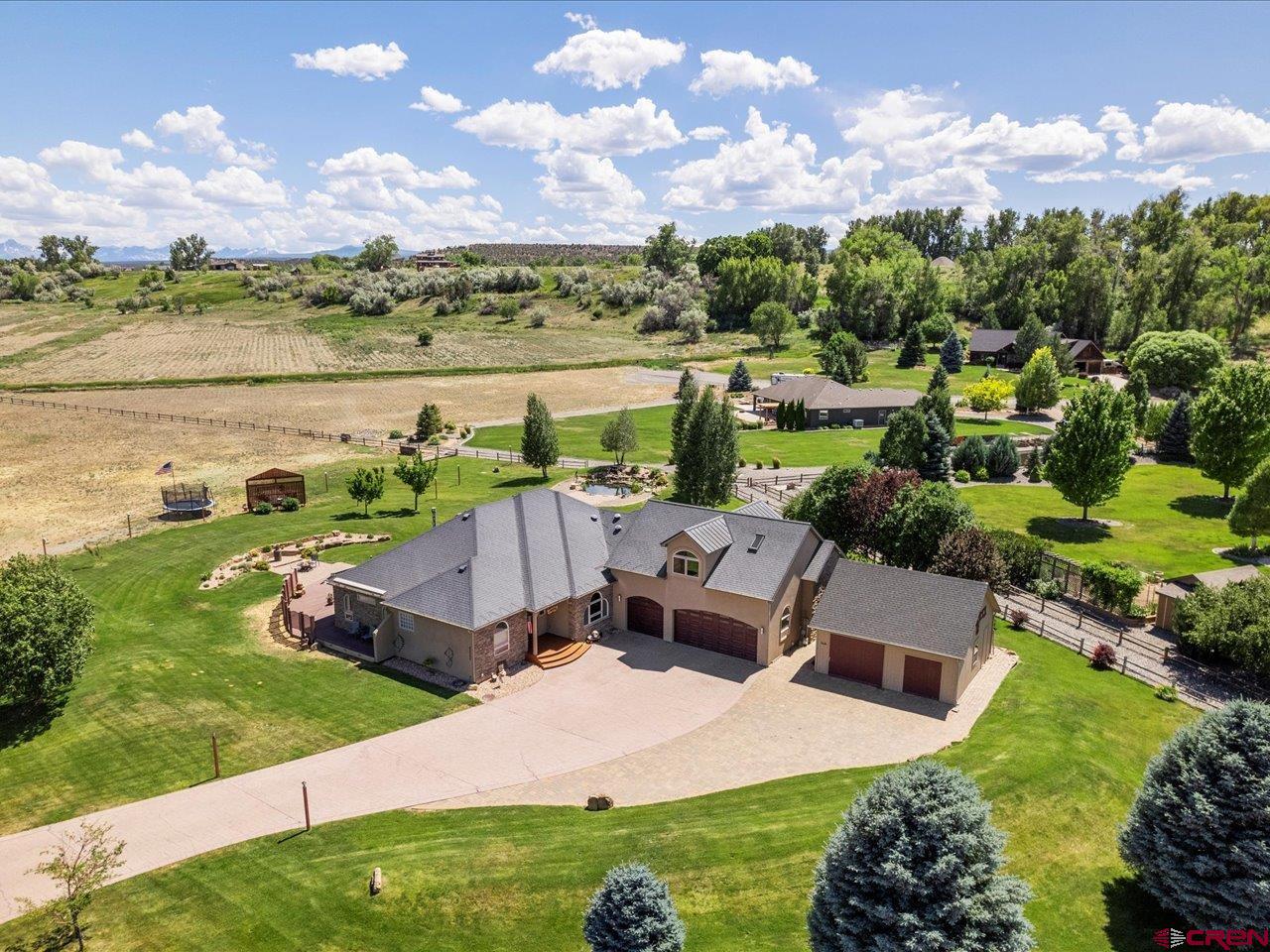 Refined mountain living – style, space & unmatched craftsmanship. Welcome to 63200 Percheron Court, where modern luxury meets quiet Colorado living. Tucked away on a cul-de-sac just minutes from town, this meticulously designed residence sits on 1.37 beautifully landscaped acres. Step inside to over 2,900 square feet of thoughtfully curated living space where comfort, style, and function blend seamlessly. The heart of the home, the chef’s kitchen, has been fully remodeled with Wolf and Sub-Zero appliances, Brazilian granite countertops, steam and conventional ovens, a pot filler, and an instant boiling/filtered water system. Whether you're cooking for two or hosting a crowd, this space delivers gourmet-level performance with timeless style. Unwind in the expansive bonus room above the garage featuring a custom bar, skylights with remote-controlled shades and ventilation. Built with comfort and efficiency in mind, the home features in-floor radiant heating, central HVAC, individual thermostats in every room, solar-powered attic fans, and a partially heated driveway and patio to keep winter worry-free. Additional amenities include a central vacuum, on-demand hot water, water softener, radon mitigation system, and a roof ice melt system. Outside, enjoy serene moments by your private backyard pond with dual waterfalls, or relax under any of the five automatic awnings that provide shade at the touch of a button. The 33’x 33’ detached shed offers excellent space for a workshop, RV/boat storage, or future studio. The oversized 3-car garage features epoxy flooring and a secure fireproof vault with an alarm system. A full home security system adds even more peace of mind. This home is approximately 75 minutes away from Telluride and approximately 105 minutes away from Crested Butte. Don’t wait, call your favorite agent for a showing today!
