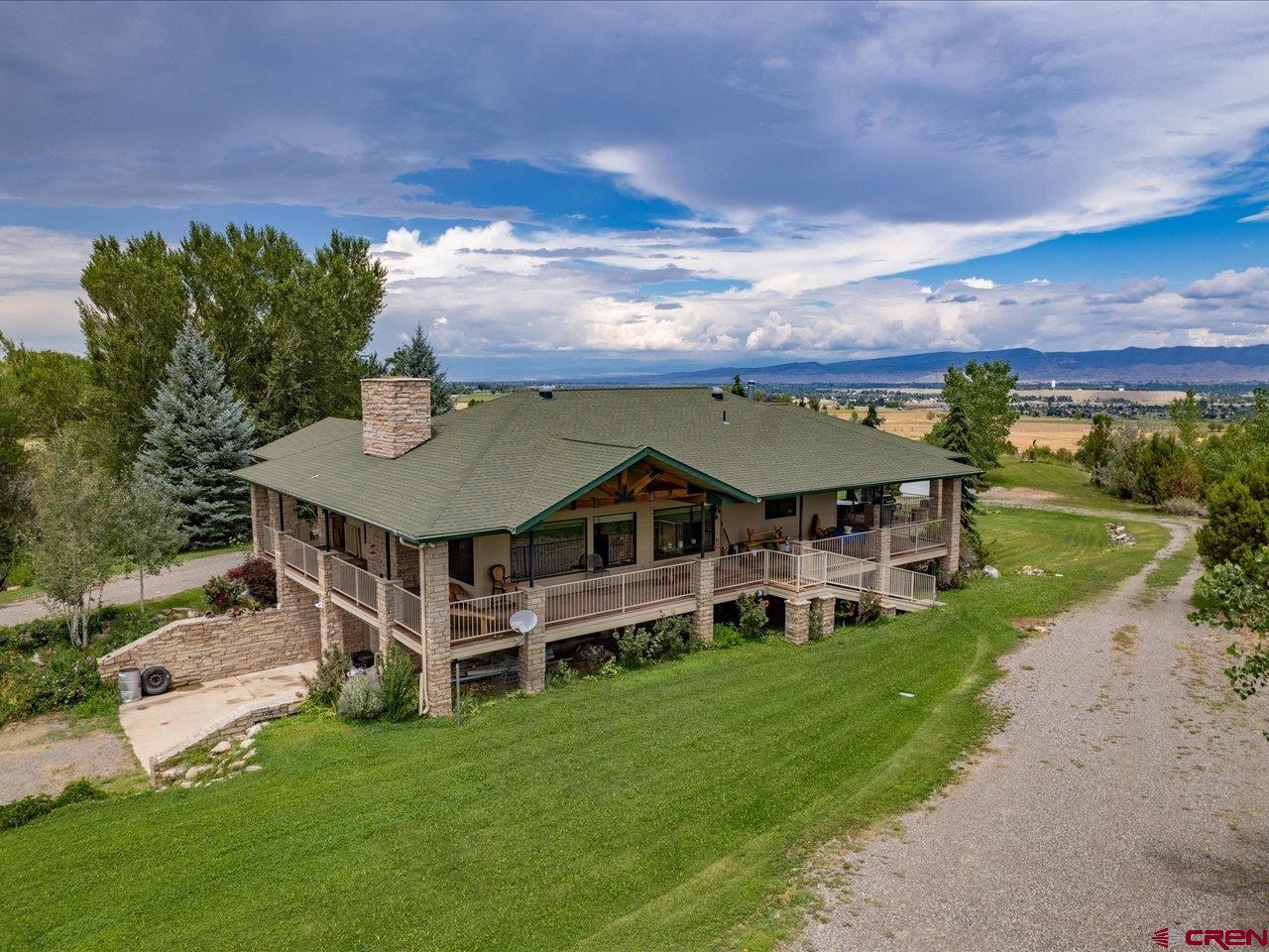 Private location. your own private retreat. Raised Ranch and Views everywhere. Over 3200 square feet of living space. 2 car over sized garage plus Porte Cochere entrance to home Custom floor plan open to Living Room, dinning area, kitchen. Living room has fireplace. All Cabinets are custom made oak. Home is served by DMEA, Black Hills Natural Gas, Chipeta Water District, Elevate Internet. Kitchen appliances are Wolf NG range, double oven, Kitchen Aid trash compactor, double dishwasher, Refrigerator. Large pantry. 1/2 bath off kitchen, large utility room, elevator to lower level. Master bedroom with door to patio. Outside deck has over 1400 square feet. Rap around 3 sides of home. great entertainment area. Lower level has 3 bedrooms, 1- 3/4 bath and 1 full bath. Large windows for great outdoor lighting. 5.08 acres irrigated. large pond. Water falls coming off the West Canal. Perfect for wedding and family photos. Location, Location, Location, Private with views.