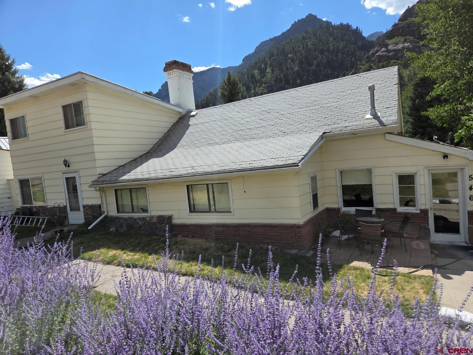 This home has been in the family for 70+ years after starting out as the Munn Brothers Assay Office in 1898, it sold to the current owners in 1953. After an addition in the 1960's it is currently set up as a 5 BR 2BA , with another room used as a bedroom which does not have a closet. The home also offers 1 formal dining area, two living areas, an eat in kitchen, a heated back porch area, a mud room in the front of the home. In addition there is a storage shed on a slab off the back patio and a storage area for lawn tools. The back yard also has an apple and plum tree. The front patio is smaller but has full view of the amphitheater and cleopatra. It's a short walk to everything in town as the home is centrally located to the Banks, Market, Post office, City Hall, County courthouse, Hardware store. Additionally the Hot springs pool as well as dining establishments and gift shops are an easy walk. You are also minutes from different places to jump on the perimeter trail and many favorite hikes are nearby including the river walk, twin peaks, dinosaur tracks, Chief Ouray trail etc.