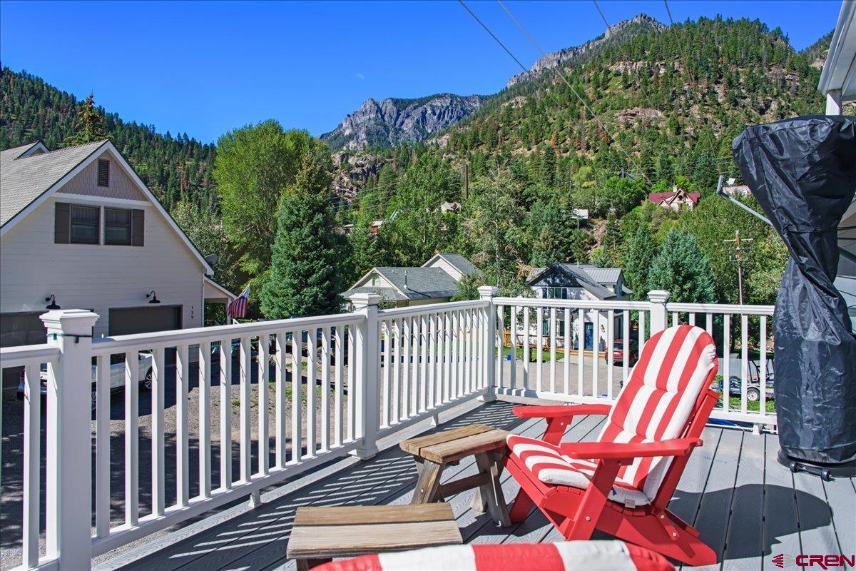 Lovely Townhome with Extensive Upgrades and Gorgeous Mountain Views!  This beautifully upgraded townhome is in like-new condition and offers the perfect combination of comfort, style, and mountain living. The owner has completed numerous recent upgrades, including a large deck off the back of the home that takes full advantage of the incredible views of the mountains surrounding Ouray.  The kitchen has been beautifully updated with granite countertops and new appliances. The primary bedroom has been remodeled and features a new bathroom and a spacious walk-in closet with a skylight. The roof was replaced just a couple of years ago, and solar was added at the same time. Natural gas was also brought to the property, and a lovely gas fireplace was added to the living area. Mini-split systems provide both air conditioning and additional heat.  The primary bedroom and main living spaces are located on the upper level, which features two decks, including one covered deck. The lower level offers two bedrooms, one bathroom, laundry, and another covered deck, providing plenty of space for family and guests.  This home is being offered fully furnished and is truly move-in ready. Whether you're looking for a convenient lock-and-leave property, a full-time residence, or a mountain getaway, this townhome is an excellent choice.  The beautifully maintained grounds, peaceful setting, and spectacular mountain views create the perfect mountain retreat or place to call home. Don't miss the opportunity to make this exceptional Ouray townhome your own. Give us a call today to schedule your private showing!