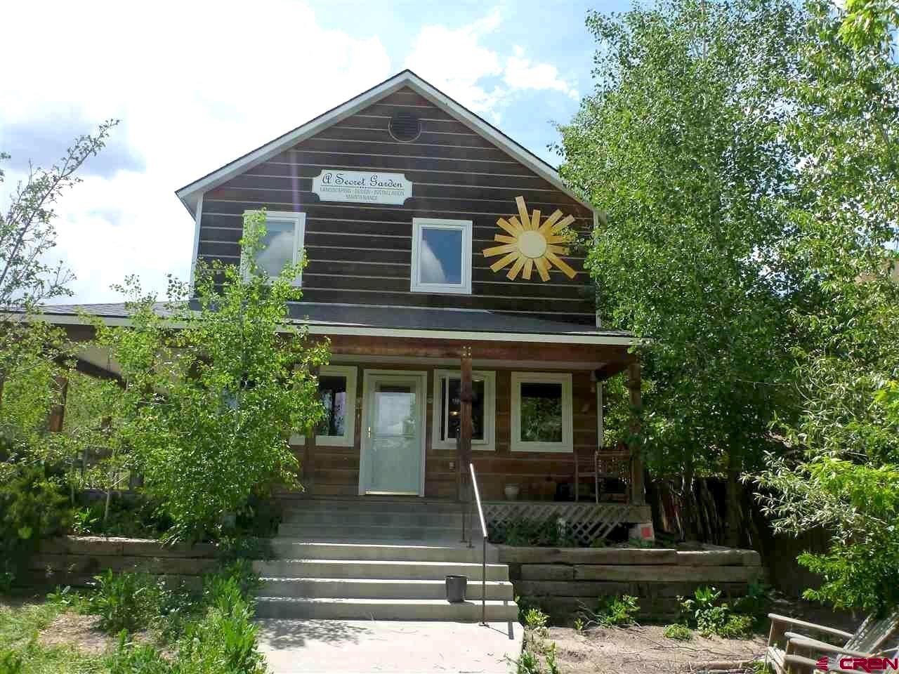 Room to Live. Land to Dream. Right in Downtown Ridgway.  Live in the heart of Ridgway with room to gather, space to grow, and an entire second lot for whatever comes next. This substantial in-town home offers the kind of comfortable footprint that is increasingly difficult to find within walking distance of Ridgway’s schools, parks, restaurants, shops and everyday essentials. Inside, generous living spaces provide plenty of room to spread out, entertain and welcome guests, while the home offers an opportunity to personalize finishes and make it distinctly your own over time. Outside is what makes this property especially compelling: an additional, fully unencumbered lot creates remarkable flexibility—hold it for privacy and open space, explore building additional residential or guest accommodations, or potentially sell it separately in the future.* It’s a rare combination of an established home you can enjoy today and land that gives you choices tomorrow, all within the easy, connected lifestyle of downtown Ridgway.