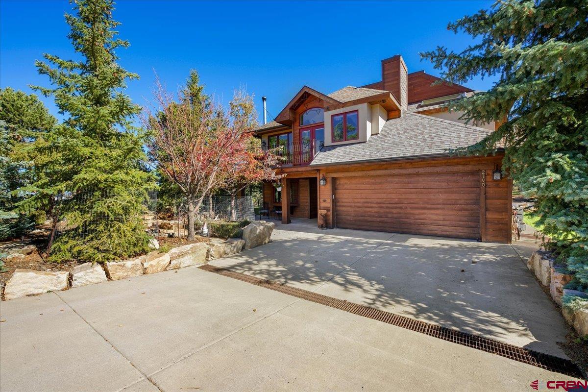 If warm, comfortable, charming, perfectly accented, quiet and peaceful coupled with views are what you are looking for then do not miss this home. The meandering driveway on the 2+ acre parcel leads you to a beautiful park like setting with a wonderful front entry area complete with a water feature, extensive landscaping, and a flagstone patio for grilling and entertaining. Entering the home you immediately feel the quality and attention to detail.  2x6 construction, slate flooring, solid Alder doors and trim with rustic hardware, and custom iron work by Jeff Skolada are only a few of the striking features. A cozy office with a wood burning stove, built in desk with granite top, window seat and sitting area invite hours of quiet work. Two bedrooms on this level share a bath featuring a granite counter and unique glass tub/shower surround. A private patio adds to this special area. The laundry room has extensive granite counter space and storage, a sink and a French door leading to the rear yard. In the yard you will find a unique wood burning hot tub, a wonderful grass area and raised planters for all your favorite flowers and vegetables. Traveling upstairs to the main level brings you to a more than special, comfortable kitchen/family room that screams “home”. The gas fireplace adds a special warmth as the family gathers around the island talking about the events of the day or sharing a meal in the breakfast nook overlooking the rear deck and forest beyond.  The kitchen is beautifully appointed with loads of counter space accented by “Blue Eyes” granite from Norway.  Stainless appliances, a unique pass thru to the dining room, and lots of glass make this such an inviting room to work in. The formal living and dining rooms are positioned near the kitchen making this open floor plan perfect for entertaining. The powder room with its custom Skolada vanity is conveniently located for guests. The master suite opens to the back deck. Two wonderful windows flank the bed. There is a walk-in closet. The bath is exceptional featuring a huge shower with marble surround, tile floor and rain head plus the tub with its marble surround and huge window that brings the outdoors in. Double marble vanities and a full mirror that gives the room such great natural light add to the specialness of this entire area. There are three decks that take full advantage of the views and offer special space to sit and relax with that first cup of coffee in the morning or a well-deserved glass of wine at night. There is also an additional very high deck ready to be used however you would like. The two car garage is heated as is the immediate apron outside the garage door.  This is a home radiating unprecedented charm and warmth in a delightful setting. Come and see for yourself.