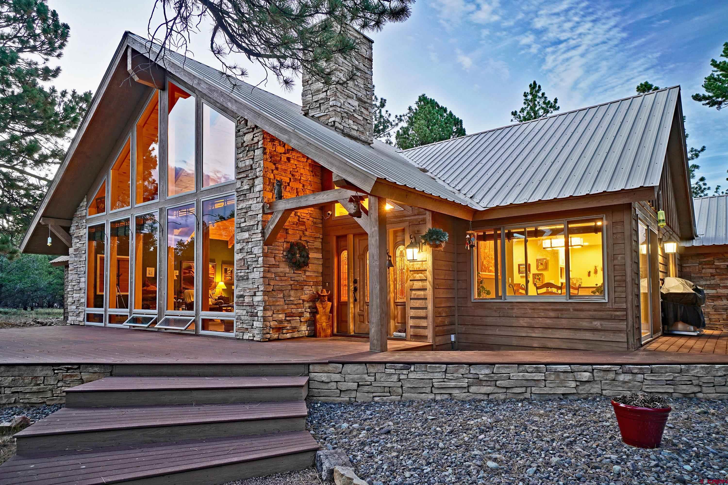 Gorgeous single level custom golf course home, incredible San Juan views (including Mt. Sneffels), and the possibility of no golf dues for the next 17 years!  The seller is offering the buyer 1st chance to purchase the remaining 17 years of their Lifetime Golf Membership!  Call broker for full details about this membership.  Seller is the 2nd owner of this home and it has been meticulously updated/remodeled during their ownership.  The first thing you'll notice when you walk into the showcase of this home, which is the living room/formal dining, is the 18+ foot vaulted ceiling and the San Juan Mountains view through the floor to ceiling windows.  German engineered laminate flooring was installed several years ago for durability and easy cleanup.  A floor to ceiling fireplace with a gas log starter is the centerpiece of this room.  Built in shelving and cabinet for TV/stereo is just to the right of the fireplace.  The large kitchen with tons of cabinet space and an enormous pantry has been updated with new cabinet/drawer fronts, granite counters, gas cooktop (electric is still there if you want to switch it back), stainless steel appliances, heavy duty stainless steel sink, glass tile backsplash, and new lighting.  You also get a peek-a-boo view of the Cimarrons from the kitchen dining area which leads out to the large deck for outdoor dining/entertaining.  The primary bedroom/bathroom was well thought out by the original owners who built the home.  There is a very large walk in closet that has a lot of space.  There is also a double-wide regular closet and a linen closet.  The primary bath has two separate matching areas separated by a walk in shower.  Each of these separate areas include newer hickory cabinets, hand forged copper sinks, slate counters and floors, and updated lighting.  Off the main living room is a 2nd bedroom with a tall vaulted ceiling and a full bath right next to it that has a newer vanity, flooring, and lighting.  At the other end of the house is the large laundry room with updated washer/dryer, slate flooring, hickory cabinet with hand forged copper sink, updated lighting, 2 large walk-in storage closets, 1/4 bath, and a furnace room.  The furthest end of the home has the 3rd bedroom.  This was originally an artist studio.  The current owners added a walk in closet to make it a legal 3rd bedroom (building permit will be provided to buyer).  It has a wood looking tile floor and updated lighting.  Finally, there is a 2 car attached heated garage with large built-in storage cabinets along an entire wall.  To top it off, there is a very large bonus room off the garage that has been updated with new flooring and lighting.  Use your imagination on the possibilities of all this extra space!  There is a $3000 golf club transfer fee to be paid by buyer. Founders level golf club membership transfers with the sale of the property. Yearly Founders level golf dues are $2052.95/year for 2026 (subject to increase in the future).  HOWEVER, if buyer wants to purchase the remainder of the seller's Lifetime Golf Membership, there will be no transfer fee for the buyer or yearly dues for the next 17 years!  Contact broker for links to HOA and golf club websites since the MLS does not allow links to be listed.  Disclosure – Listing broker (Anthony Litschewski) is a trustmaker and trustee of the trust that owns this property.