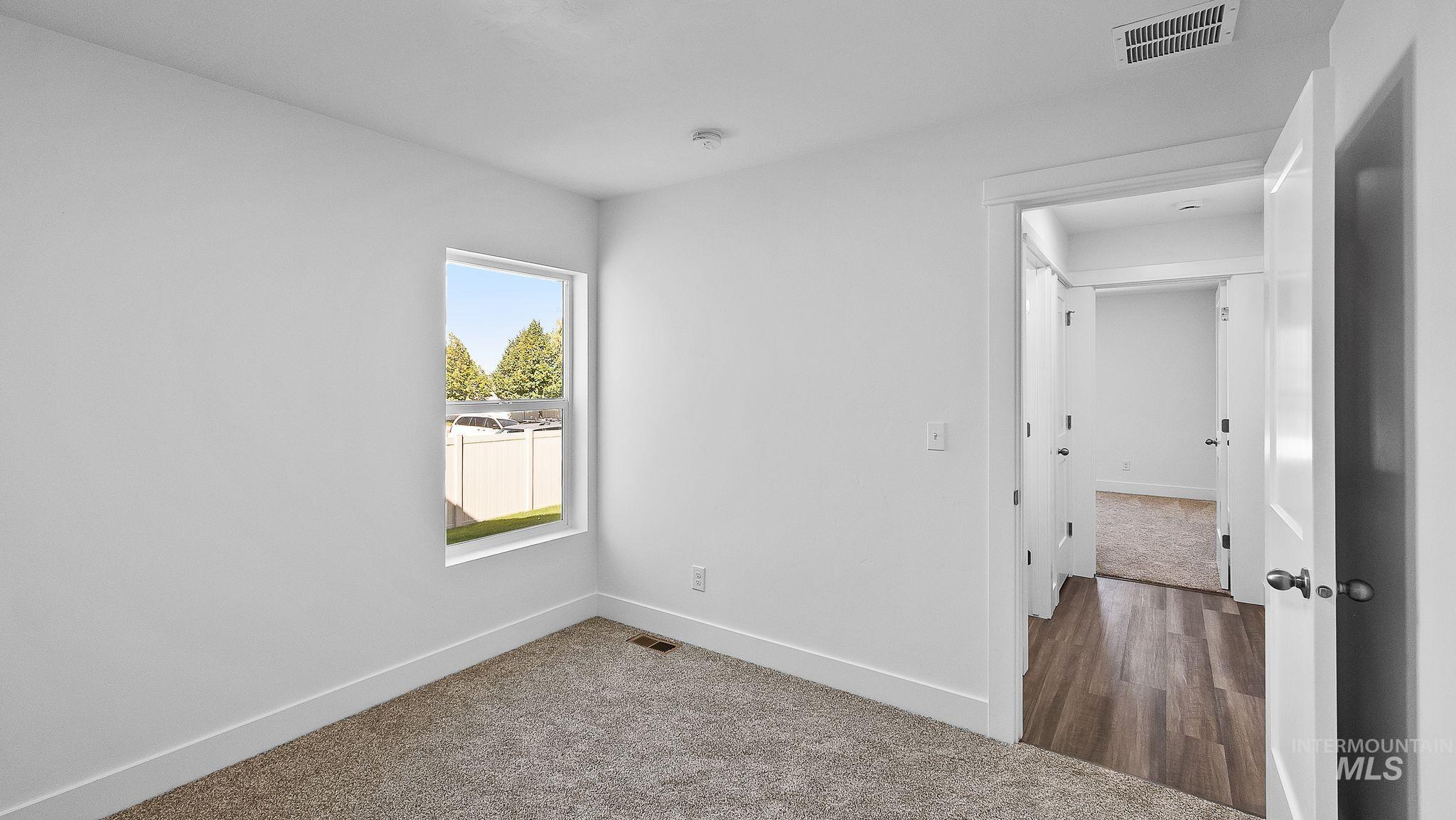 Unfurnished room with dark carpet