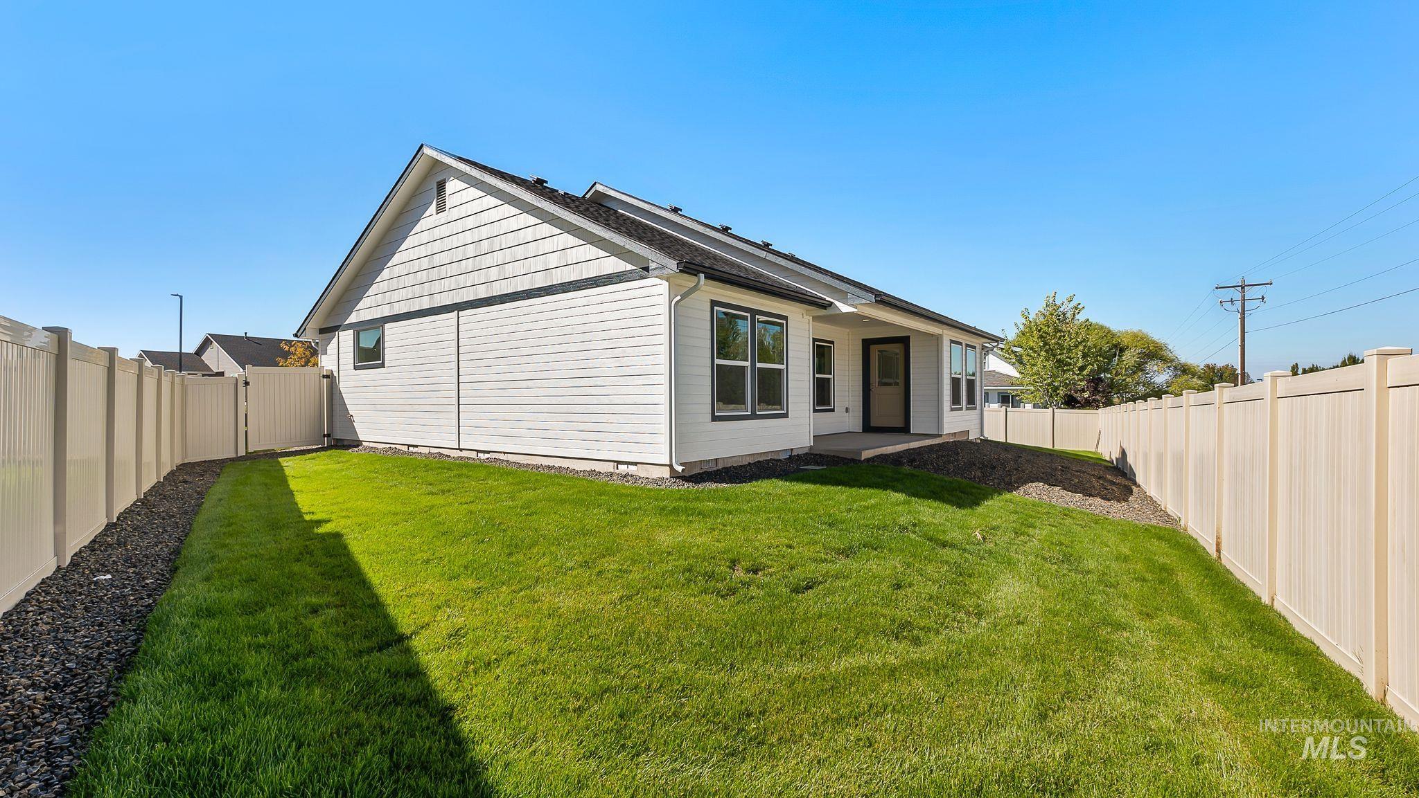 View of side of property featuring a patio area and a fenced backyard