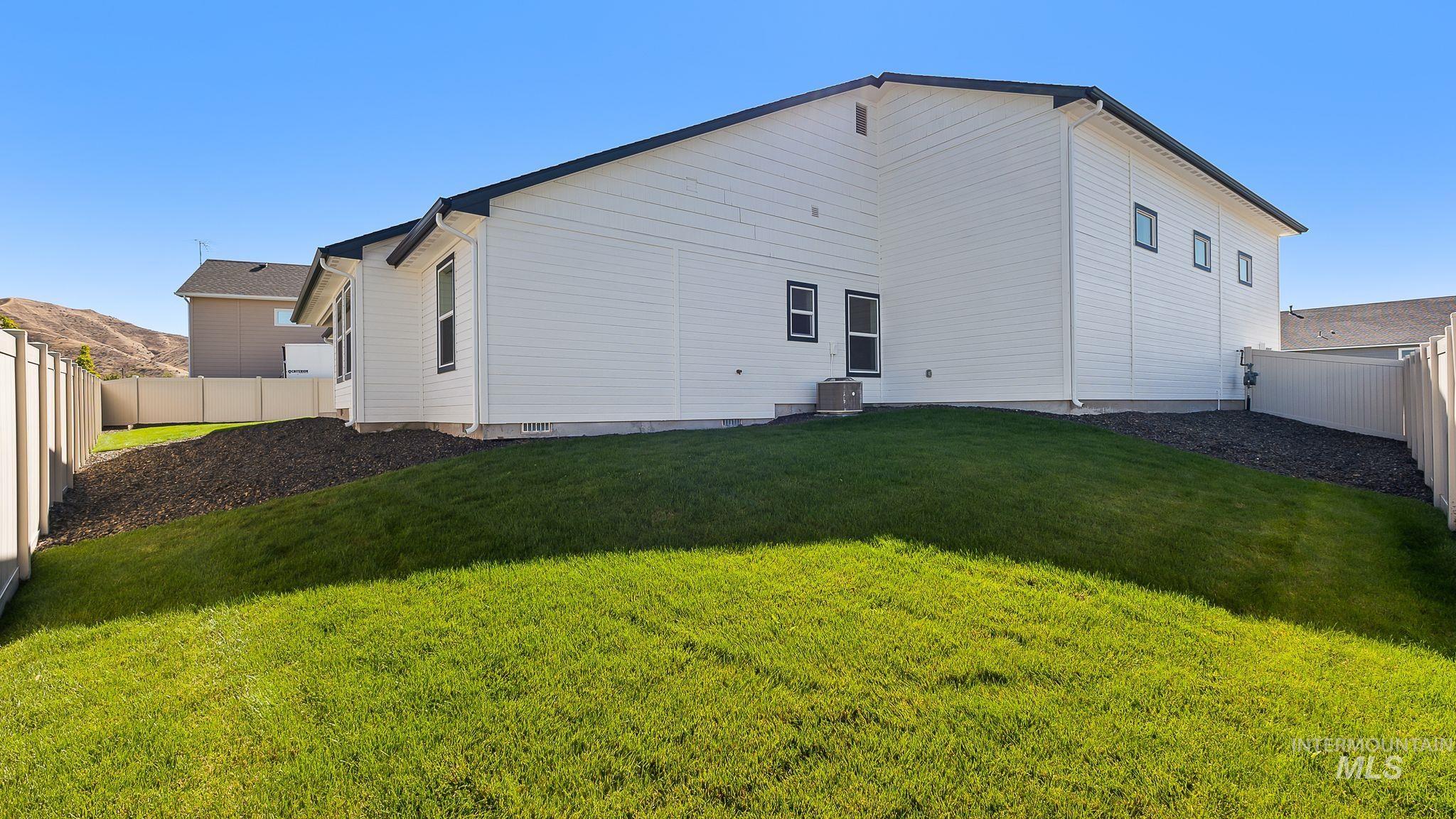 Rear view of property with a fenced backyard