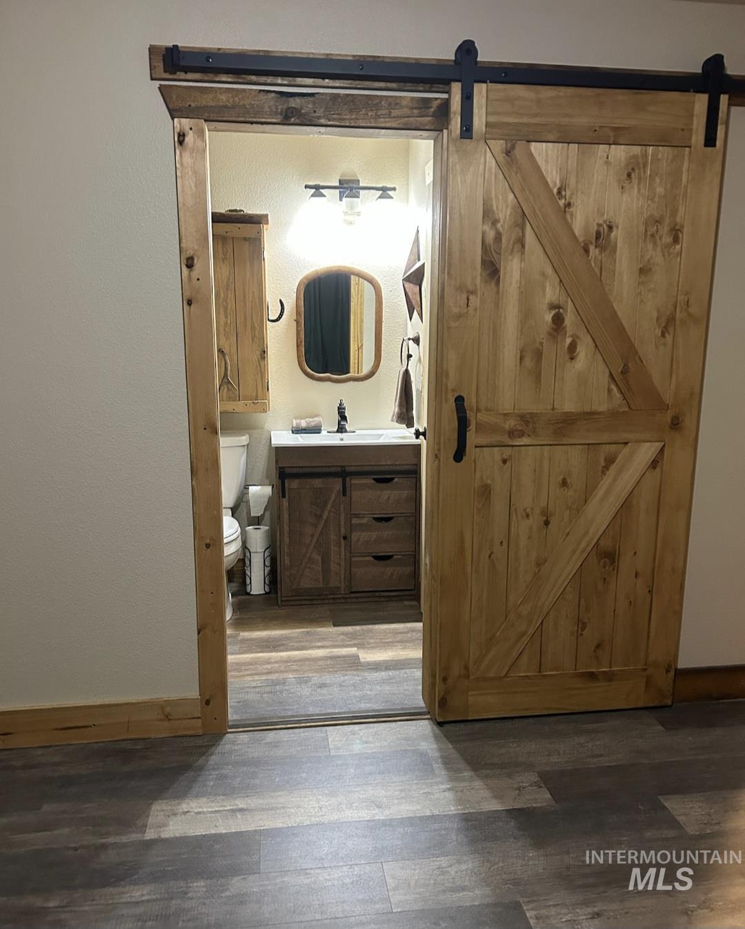 Bathroom with vanity and wood finished floors