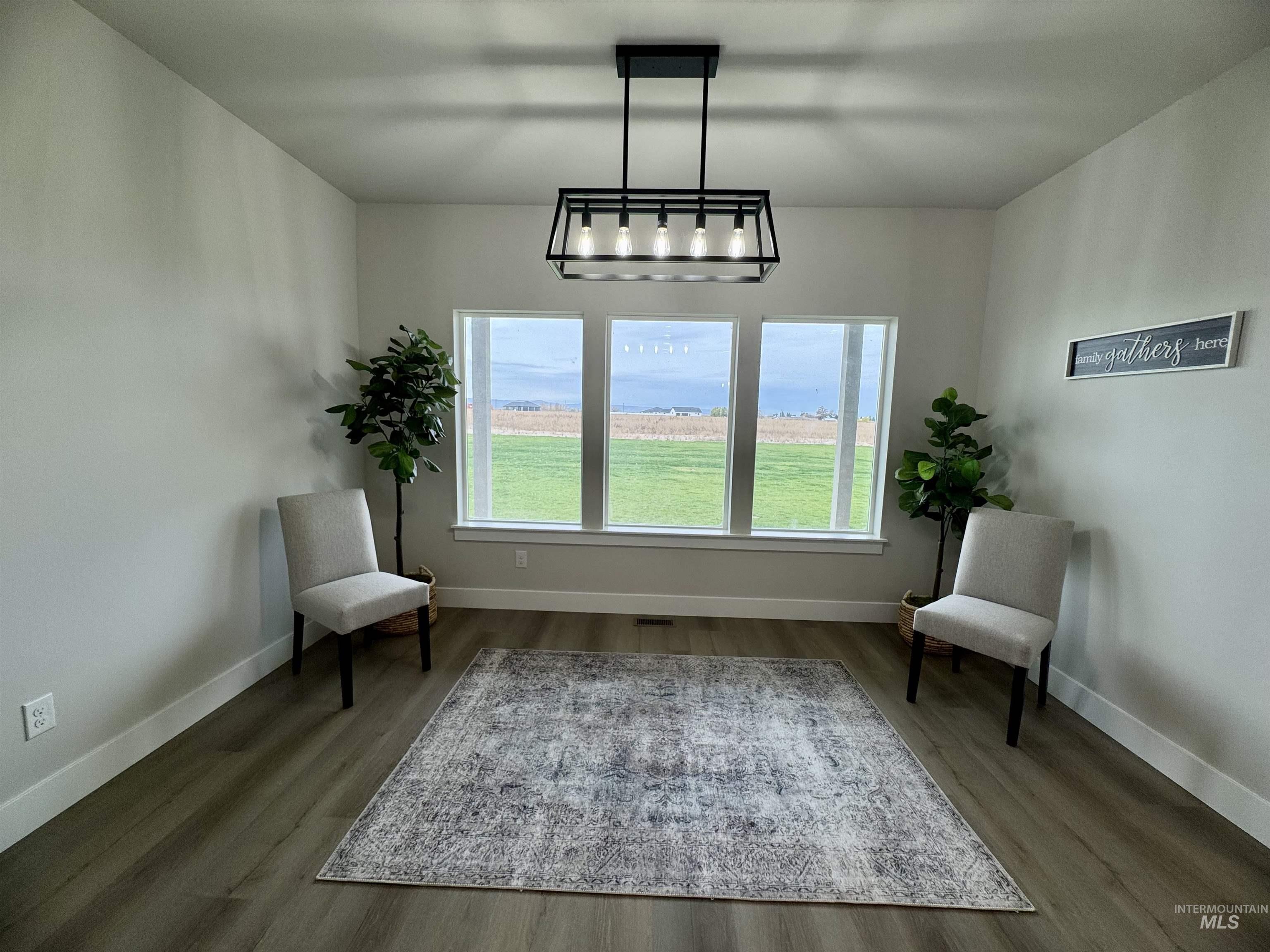 Sitting room with dark wood-type flooring