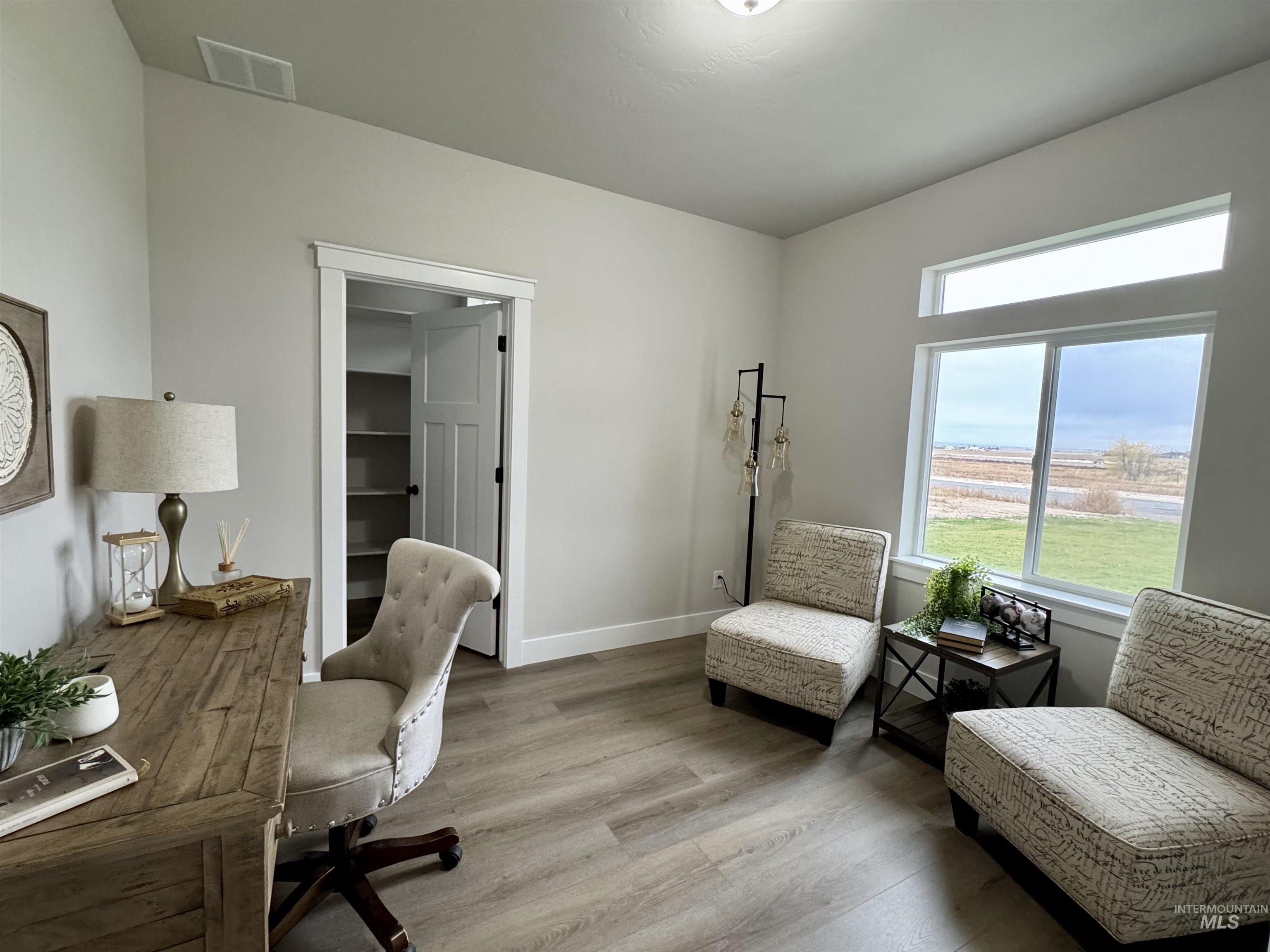 Office space featuring light wood-style flooring and baseboards