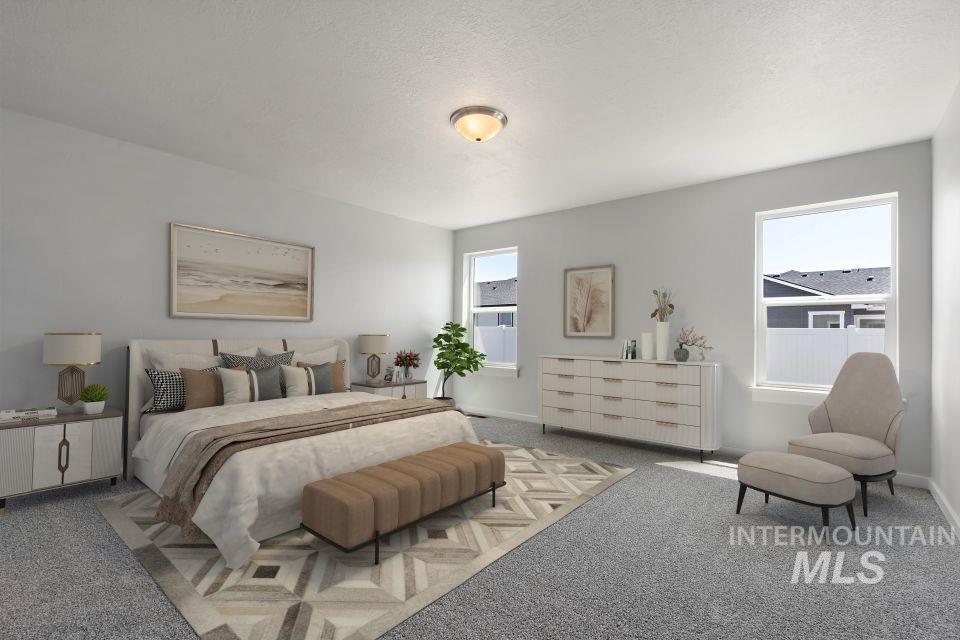 Carpeted bedroom featuring baseboards and a textured ceiling