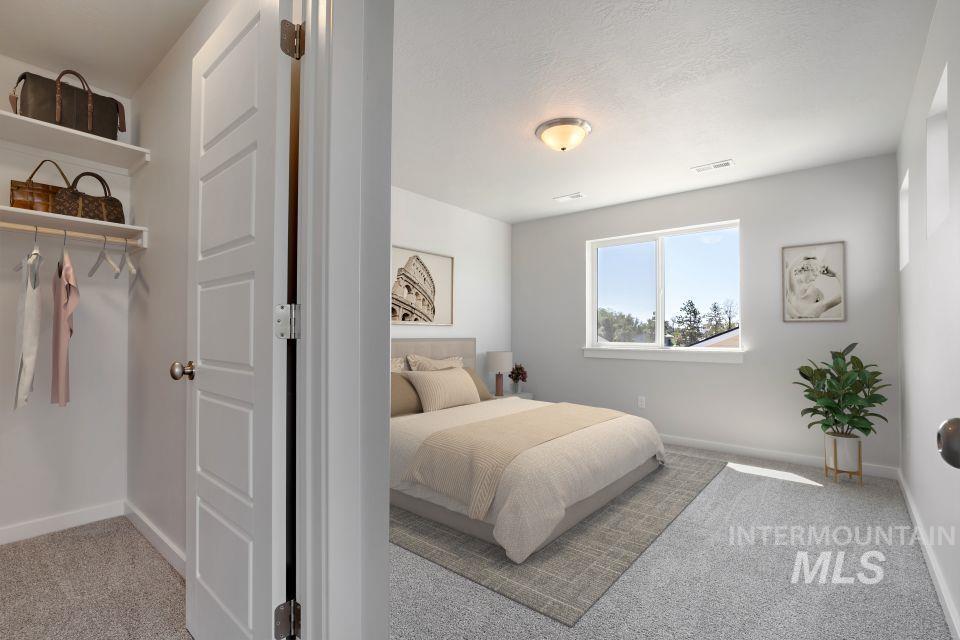 Bedroom with carpet and a textured ceiling