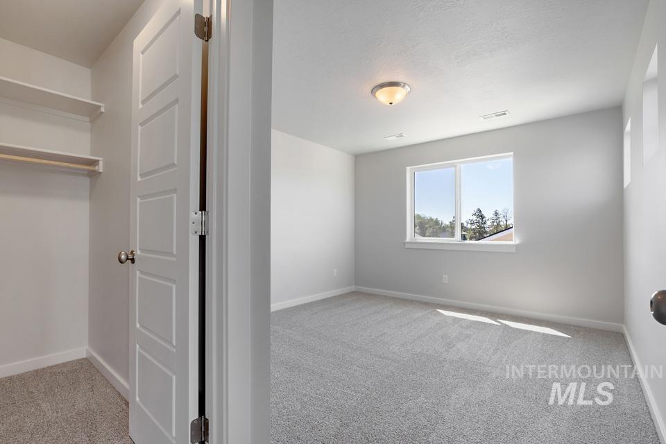 Unfurnished bedroom with carpet and baseboards