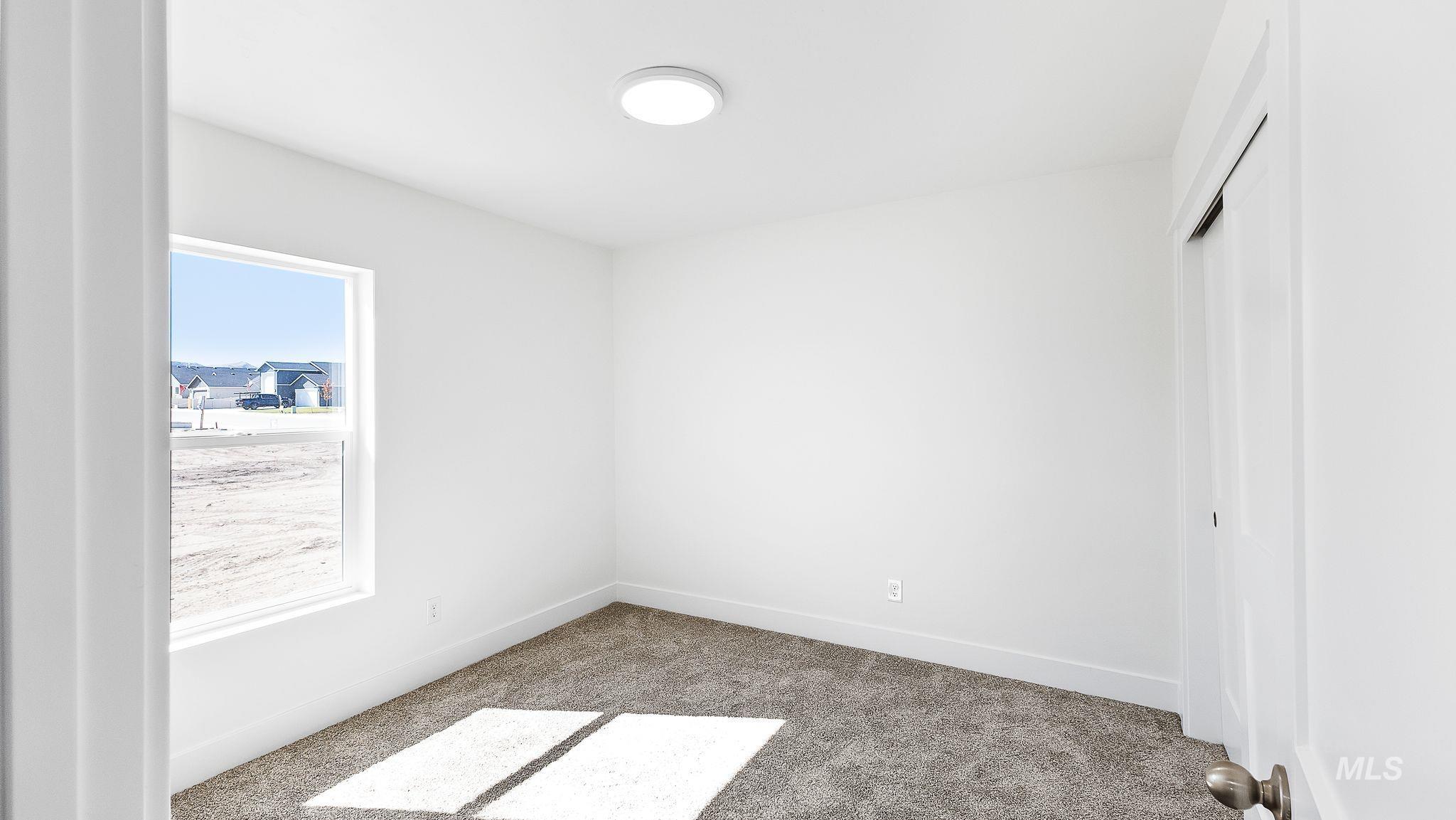 Unfurnished bedroom featuring carpet and baseboards