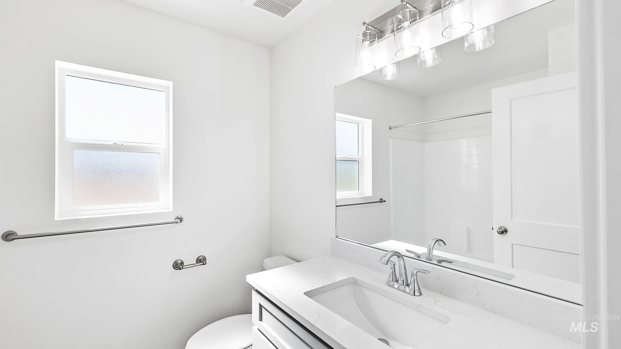 Full bath with vanity and a shower