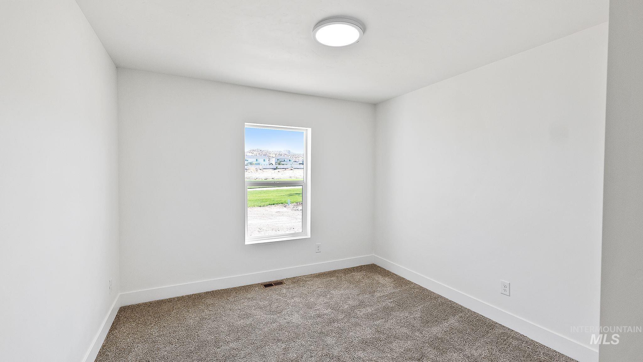 Spare room with carpet flooring and baseboards