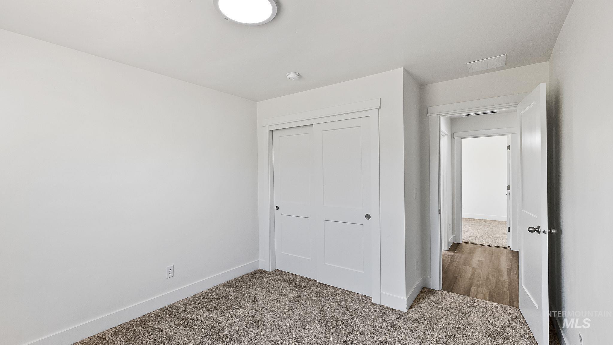 Unfurnished bedroom with carpet flooring and a closet