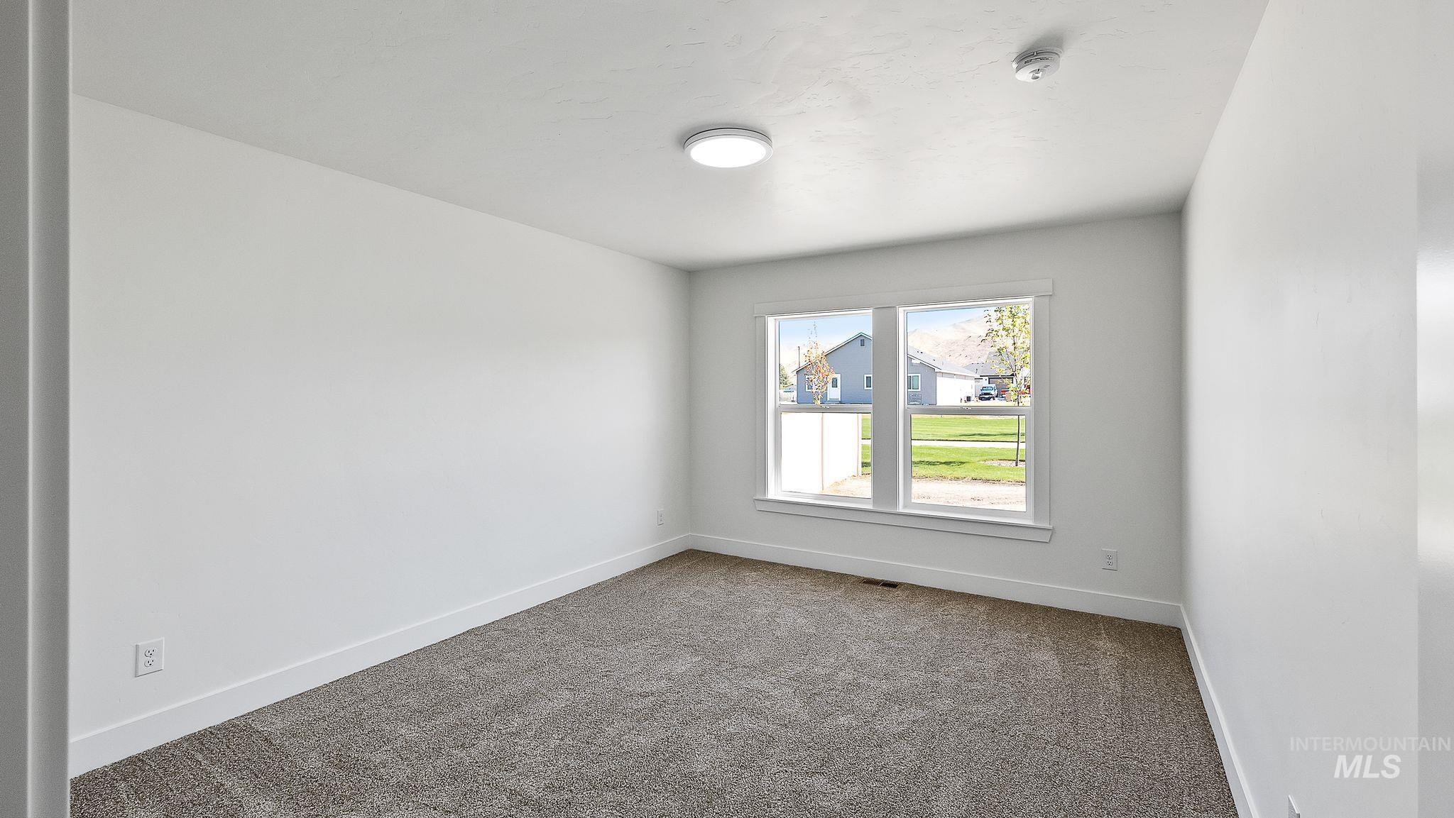 Carpeted empty room with baseboards