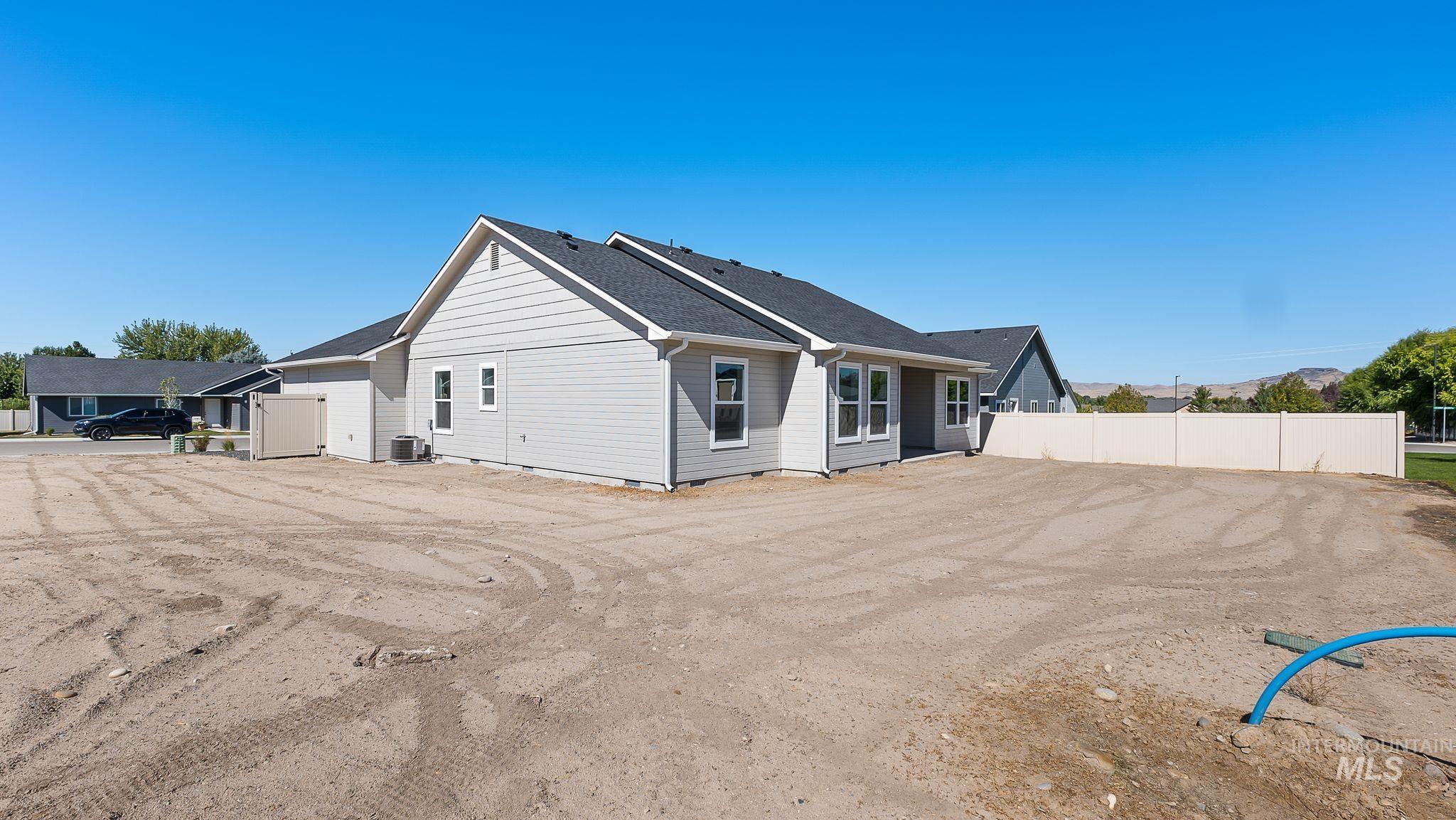 Rear view of house featuring roof with shingles