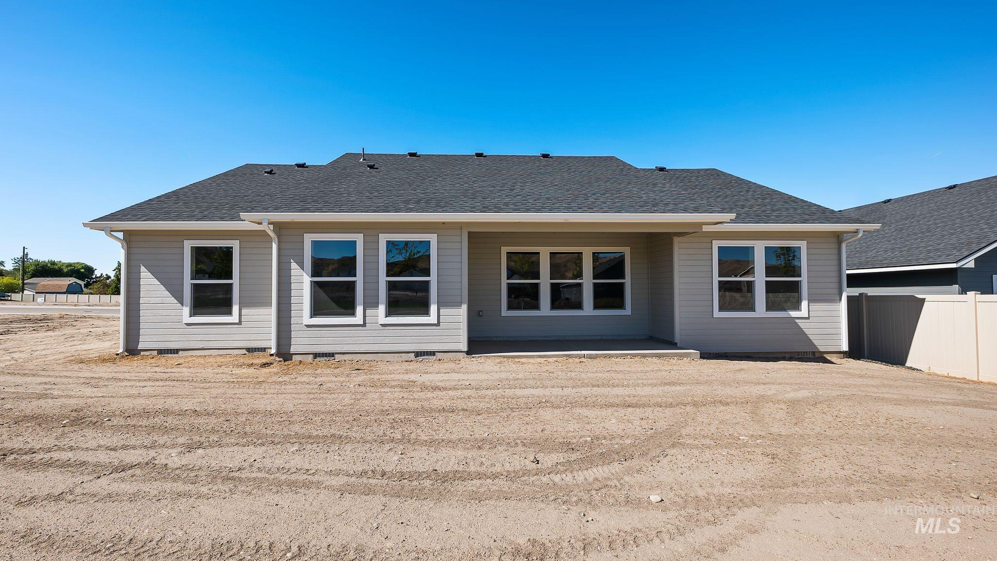 Back of house featuring a shingled roof, a patio, and crawl space