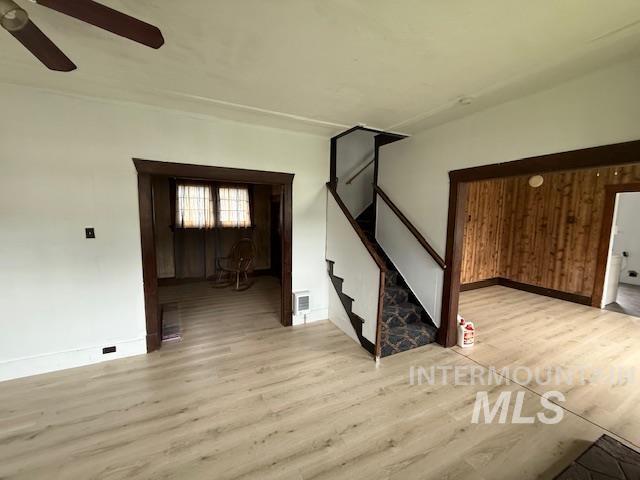 Empty room with light wood-type flooring and stairs