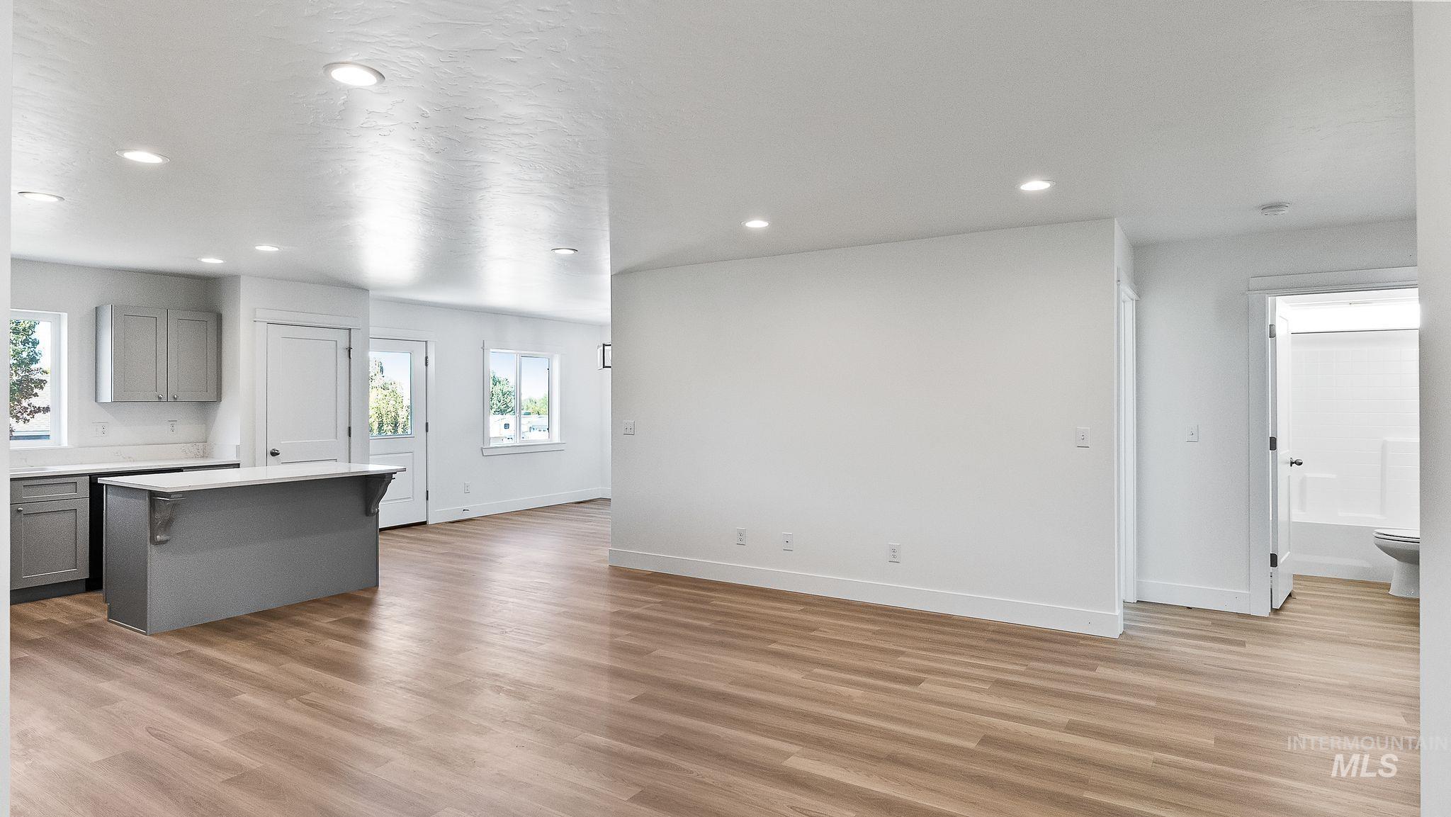 Unfurnished living room featuring light wood-style floors and recessed lighting