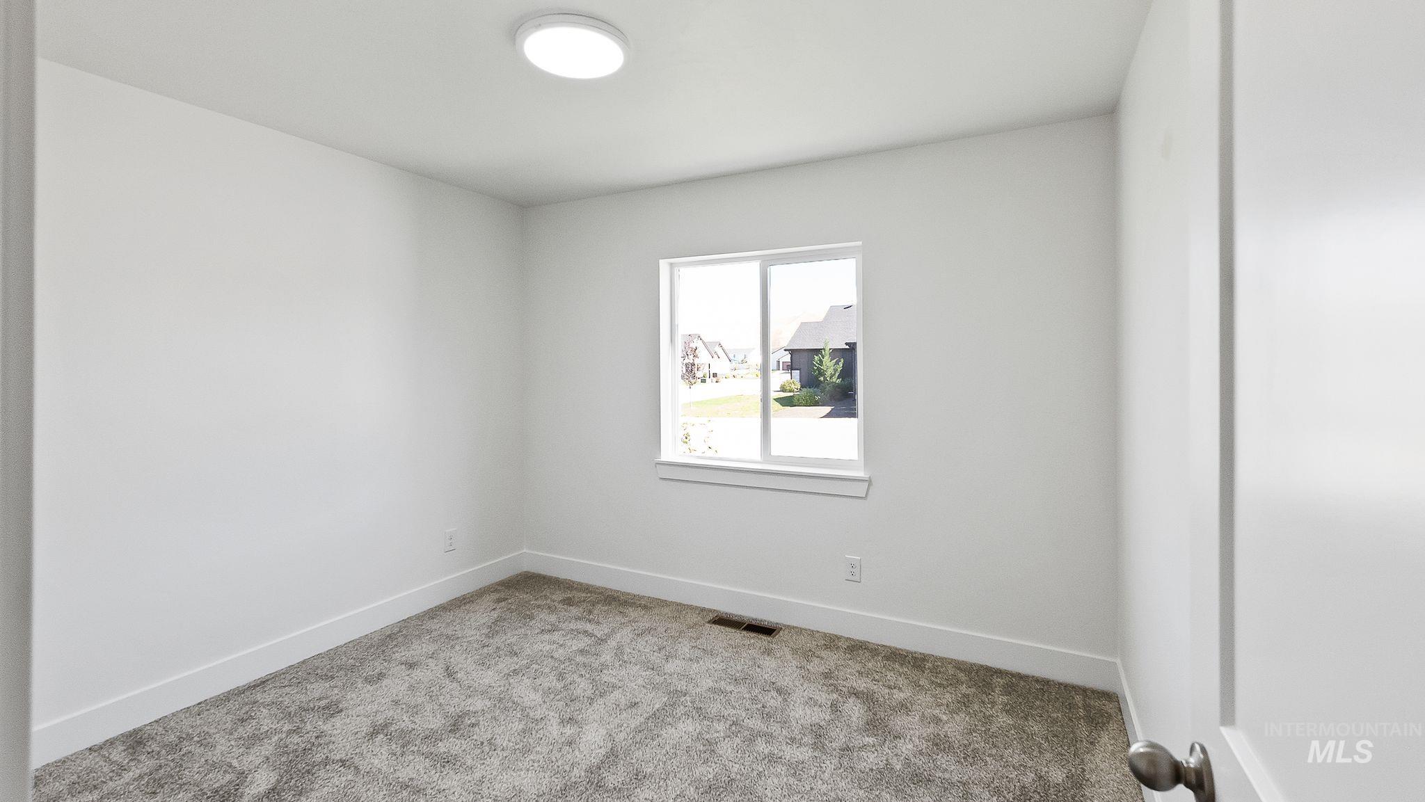 Empty room featuring carpet floors and baseboards
