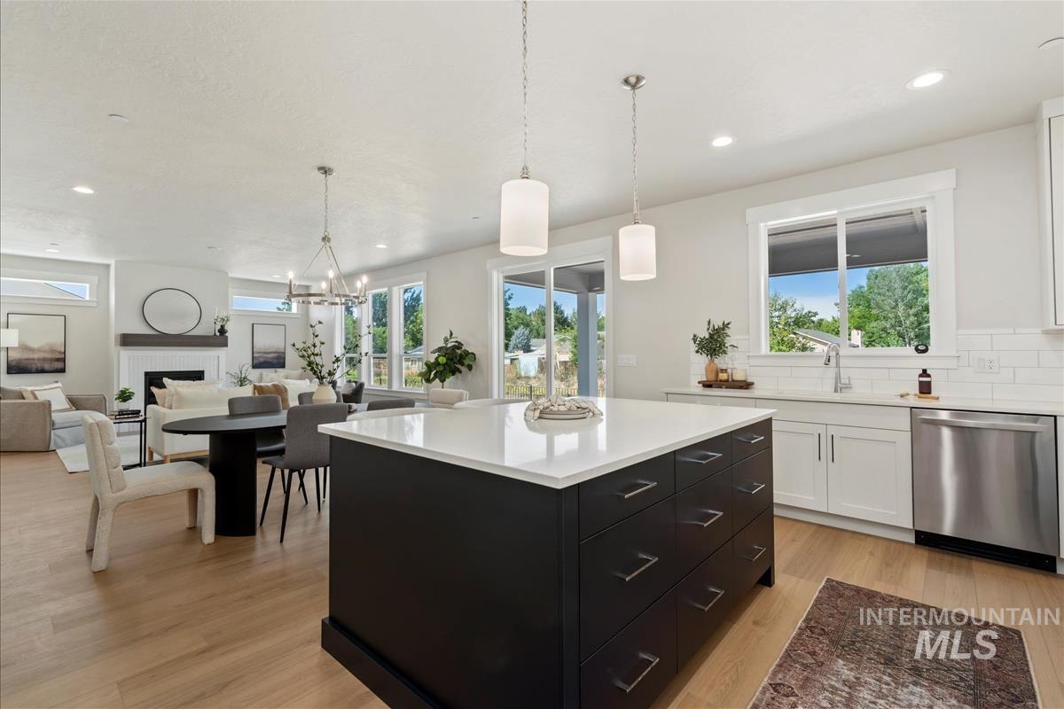 Kitchen with dark cabinetry, white cabinets, dishwasher, light countertops, and recessed lighting