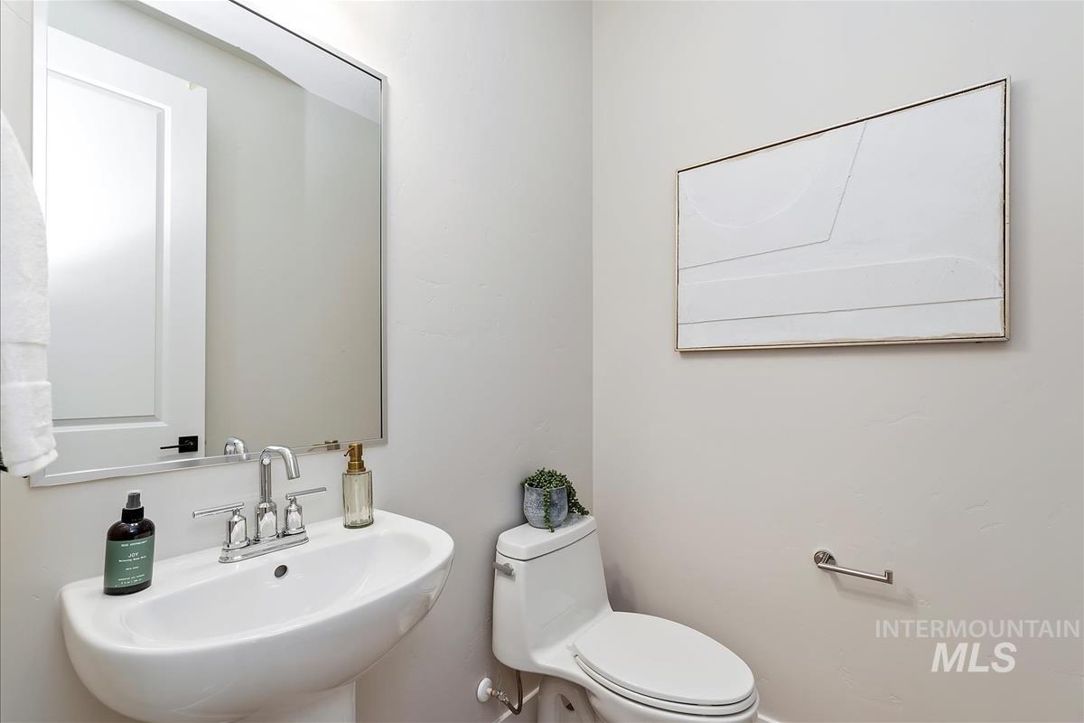 Half bathroom featuring a sink and toilet